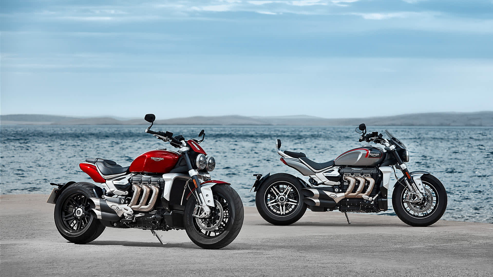 Static shot of the Triumph all-new Rocket 3 R in Korosi Red and GT model in Silver Ice & storm grey