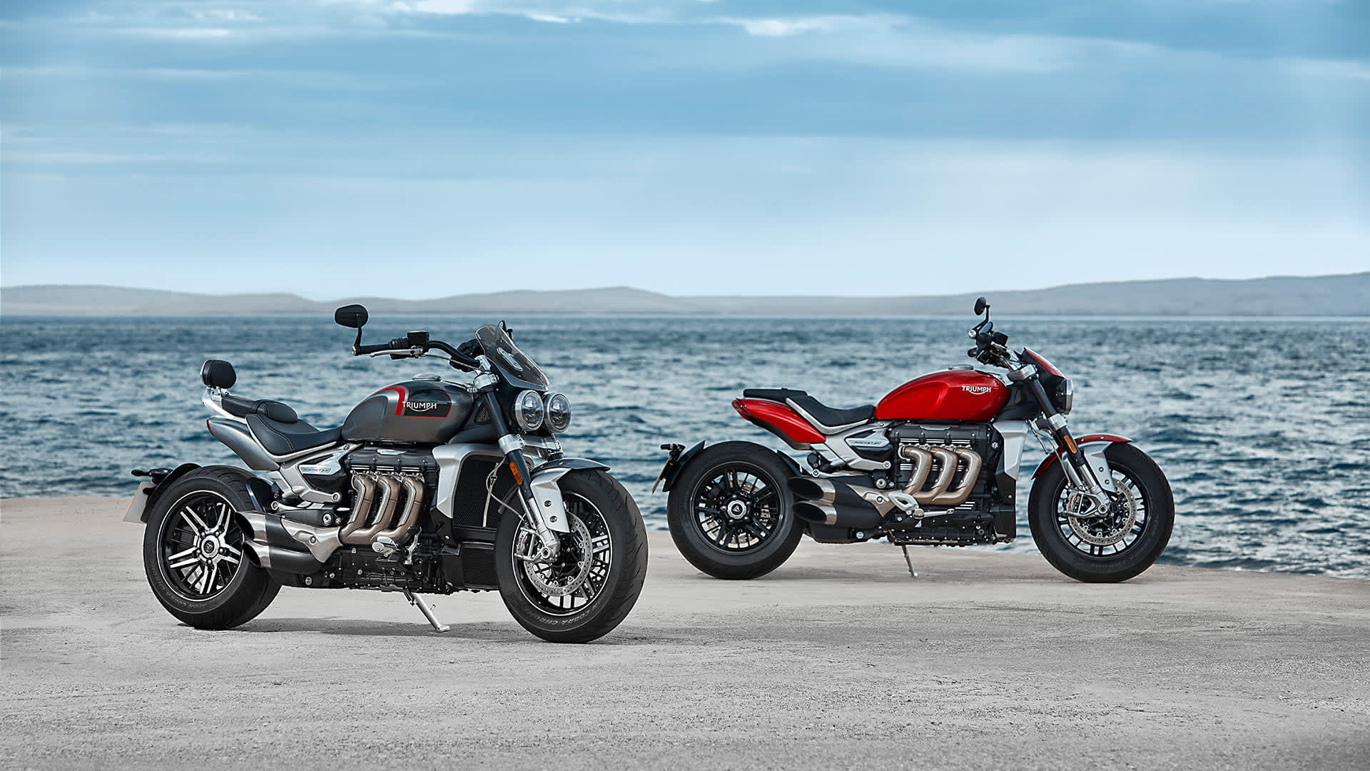 Static shot of the Triumph all-new Rocket 3 R in Korosi Red and GT model in Silver Ice and storm grey