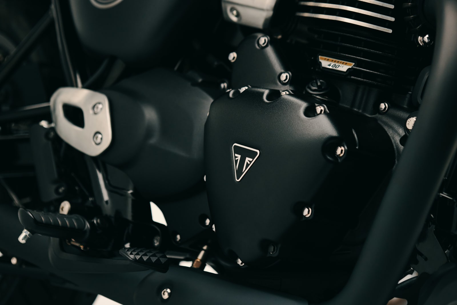 Close-up of the black engine cover with the Triumph triangle badge on the Bonneville T40 Black