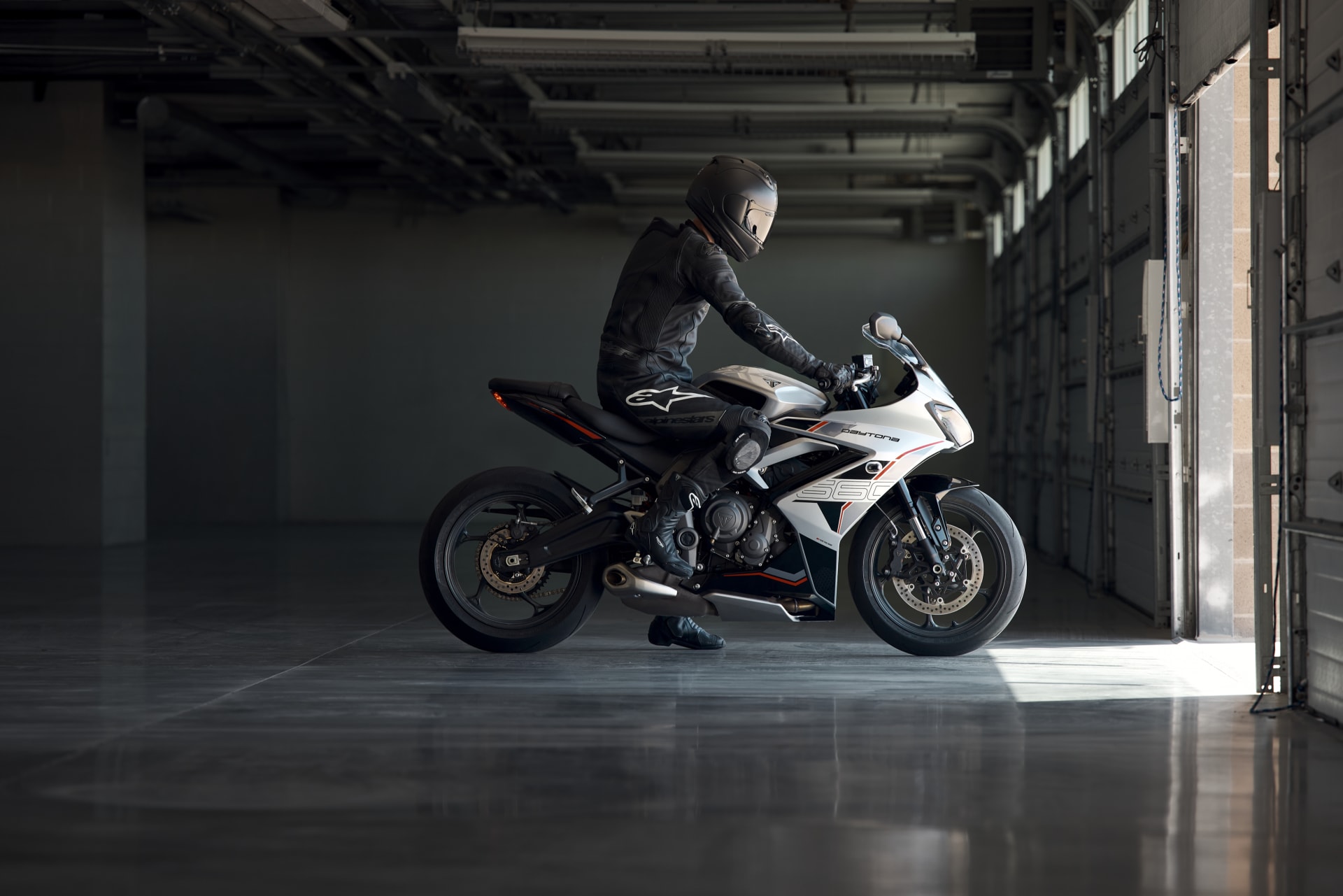 Side view of a rider sat on Triumph Daytona 660 in Aluminium Silver