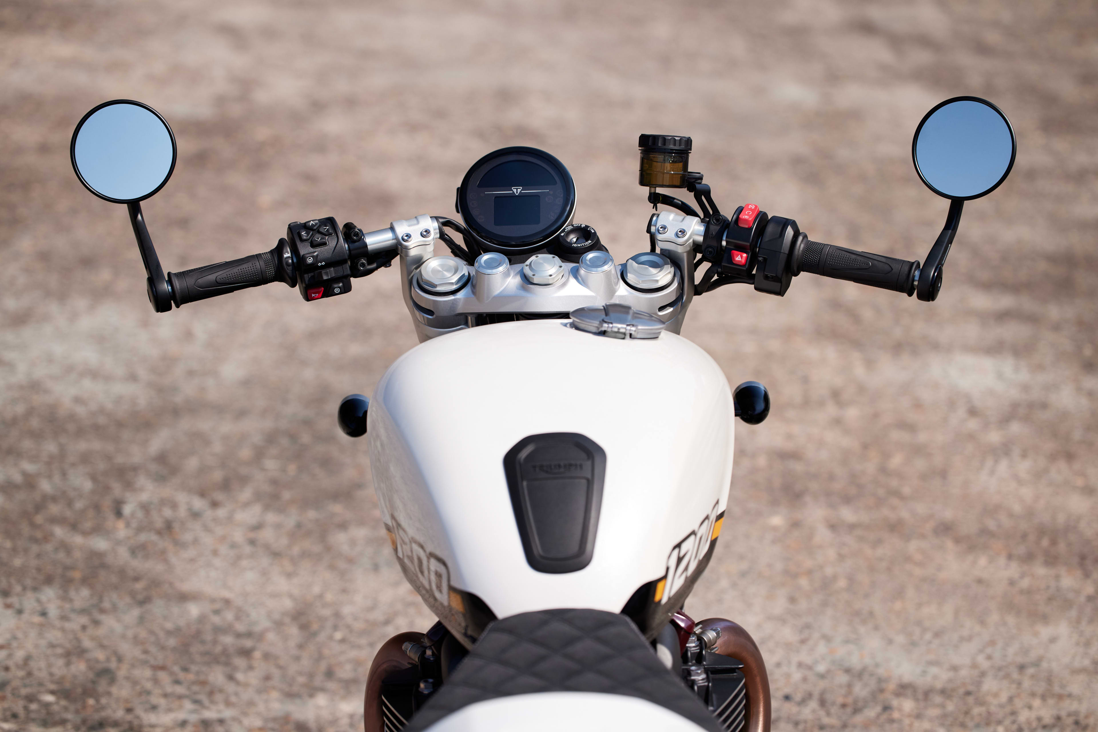 Rider angle point of view of Triumph Speed Twin 1200 with fuel tank, speedometer and handles visible