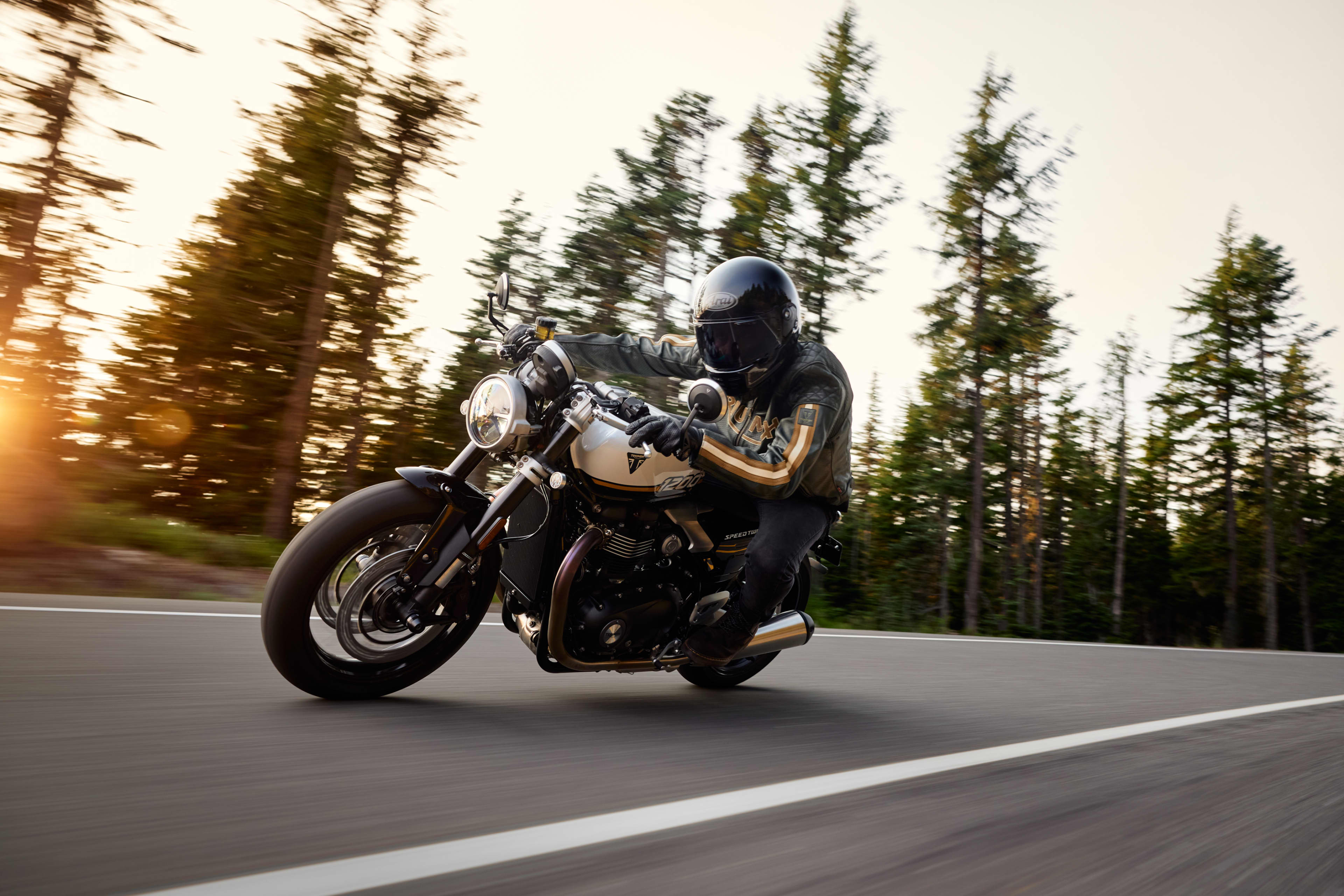 Side view riding shot of rider leaning while riding Triumph Speed Twin 1200