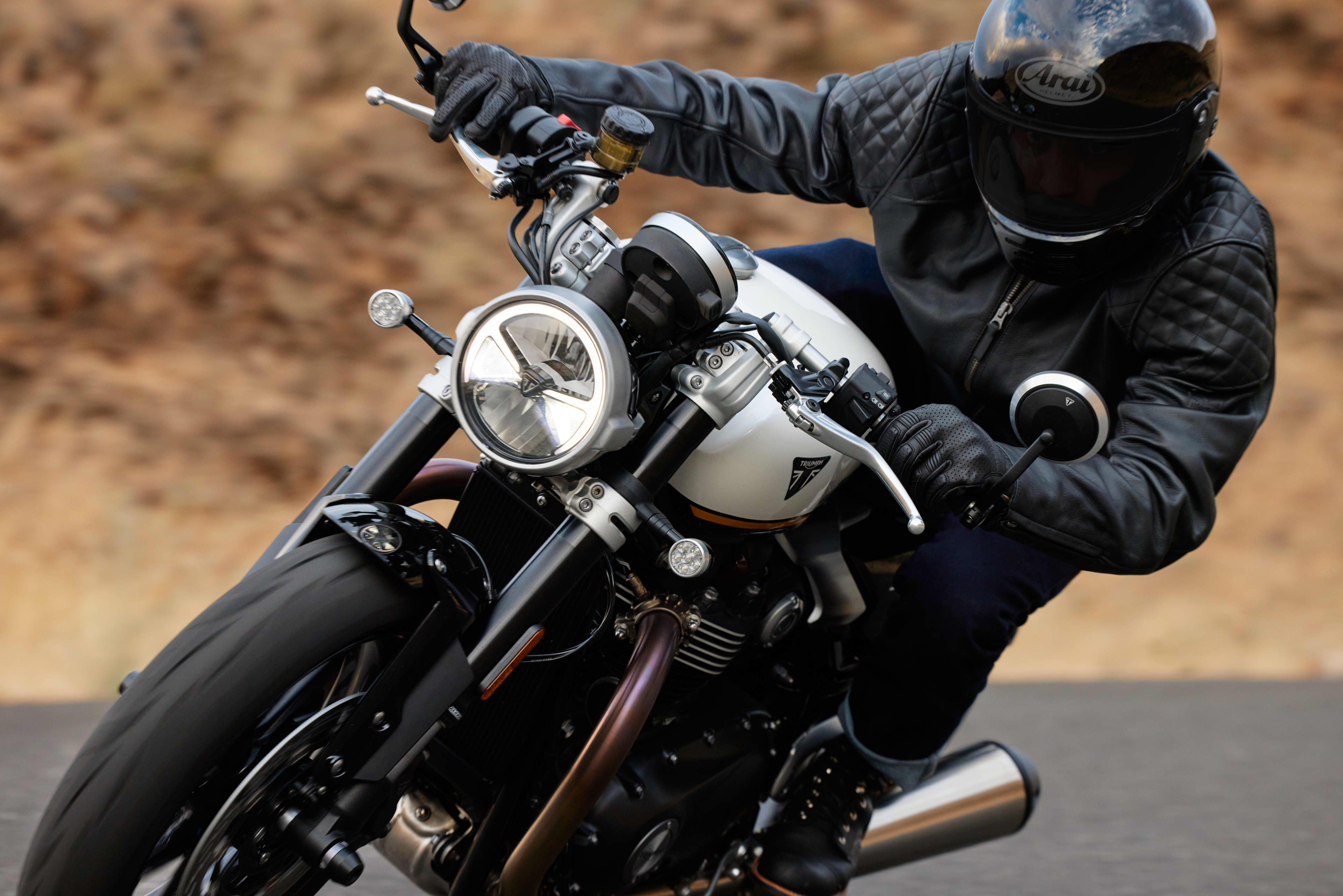 Close up angled front view riding shot of Triumph Speed Twin 1200