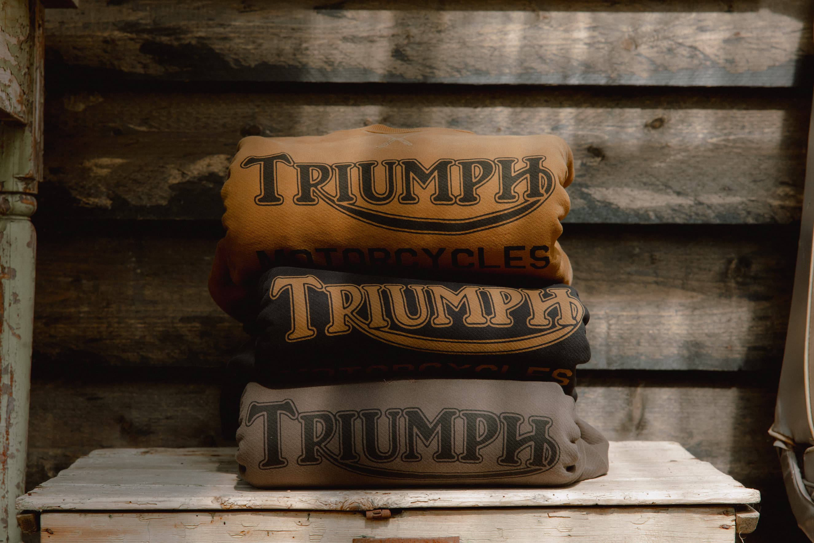 Stack on three Triumph Motorcycles Heritage Radial Logo Sweatshirts