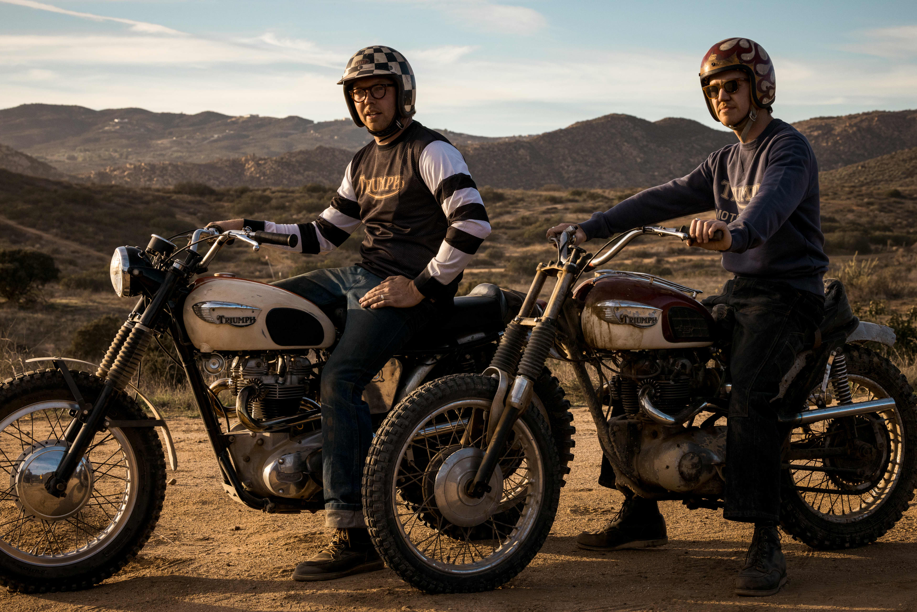 Two men in the desert sat on their Triumph Motorcycles wearing Heritage clothing