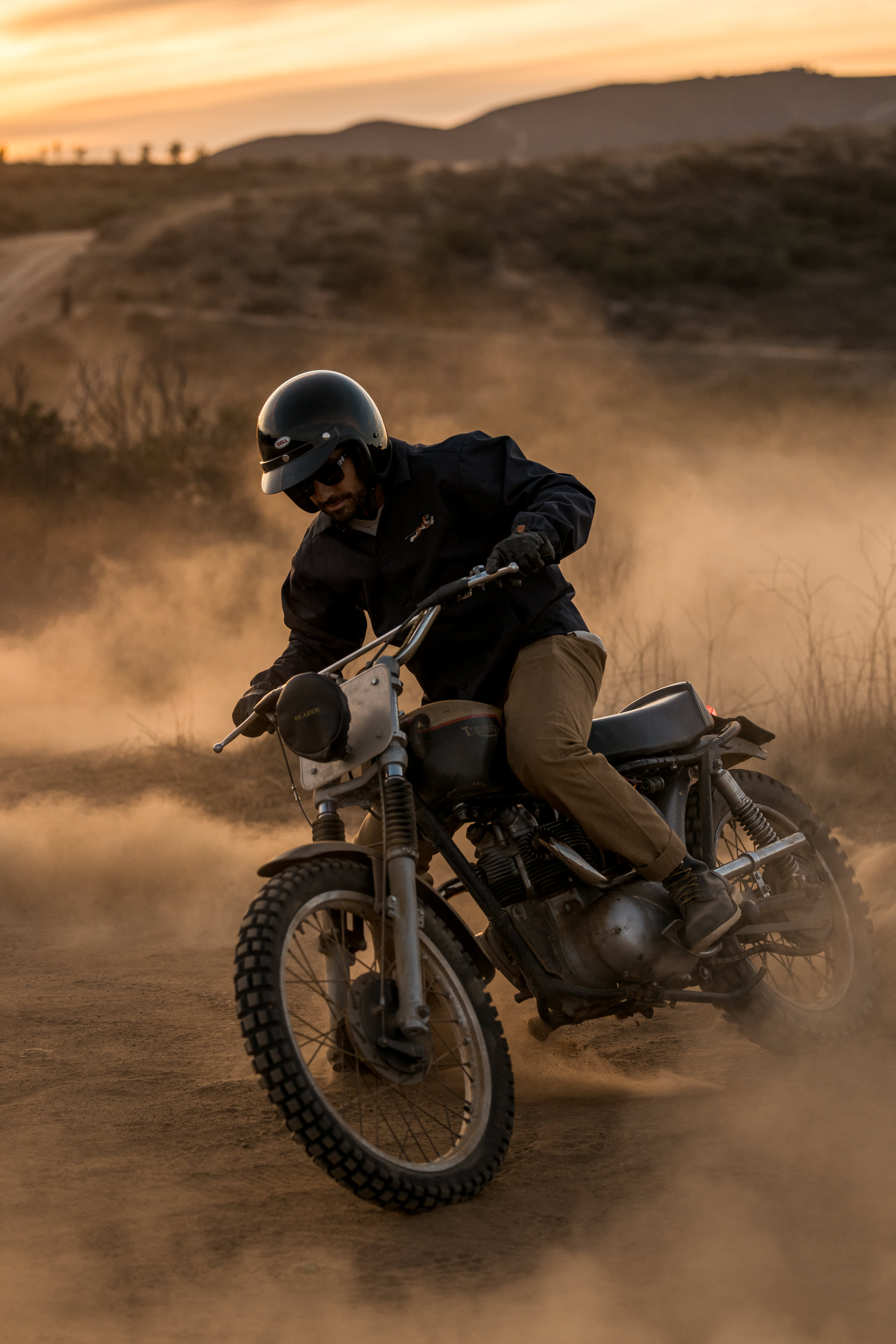 Close up of man wearing a Triumph Motorcycles T-Shirt while riding Triumph Motorbike