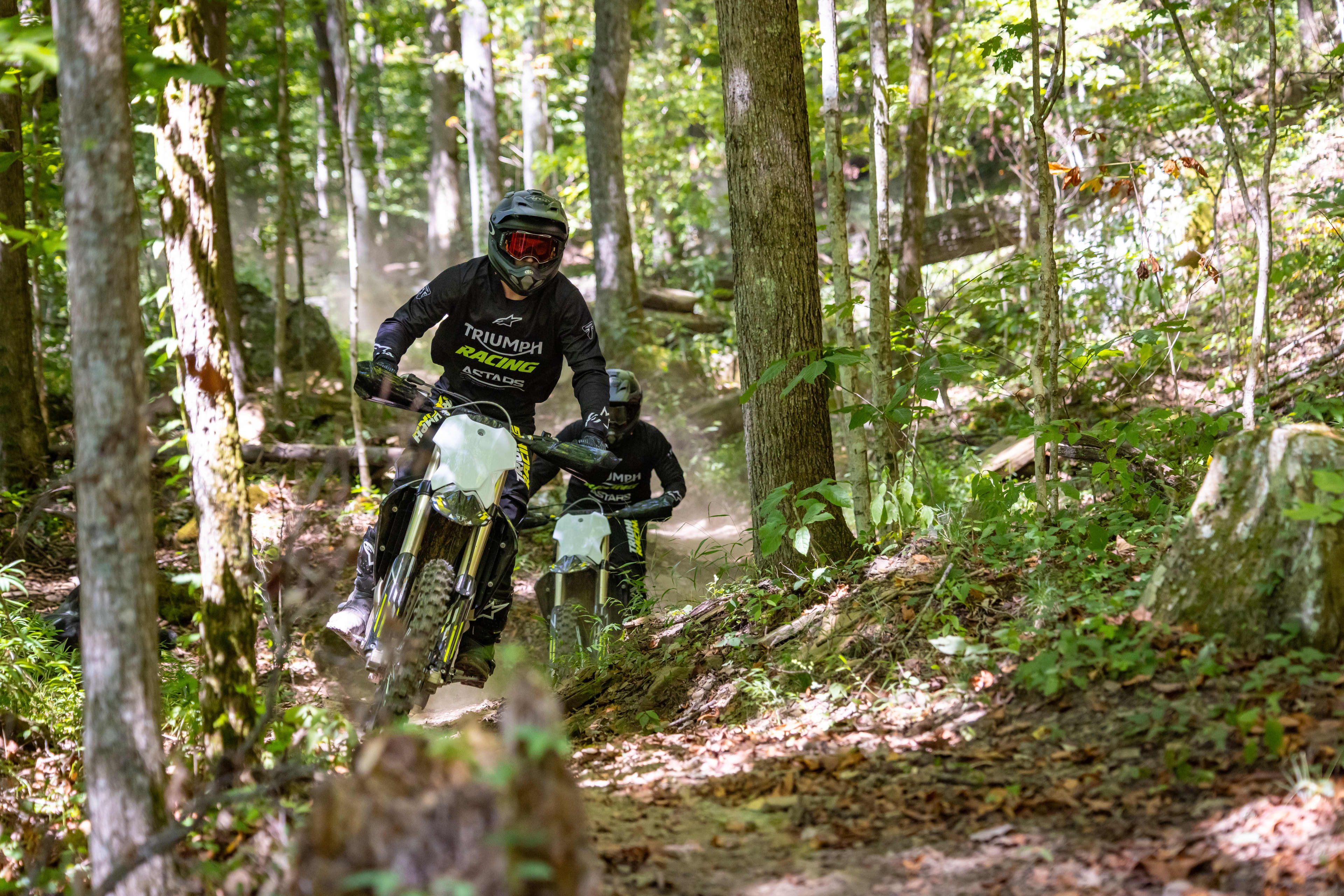 Triumph Cross Country motorcycle scrambling through the forest