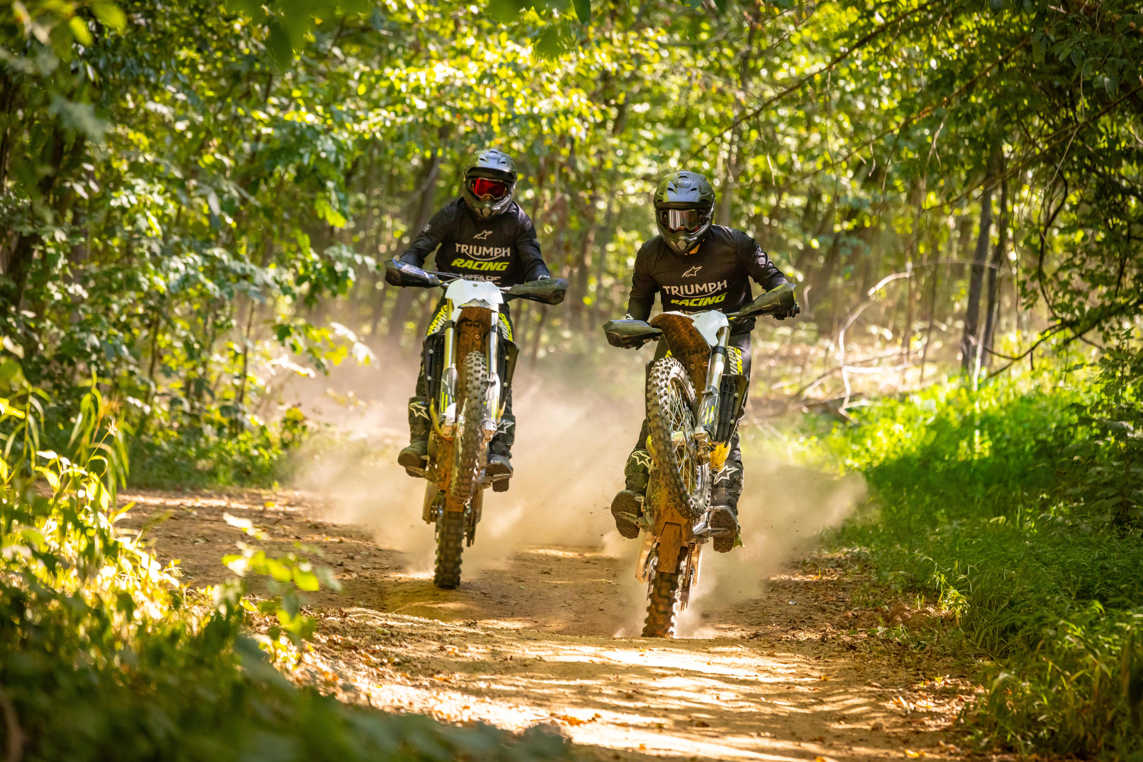 Cross Country TF 250 & 450-C with stunt riders off road riding through a forest