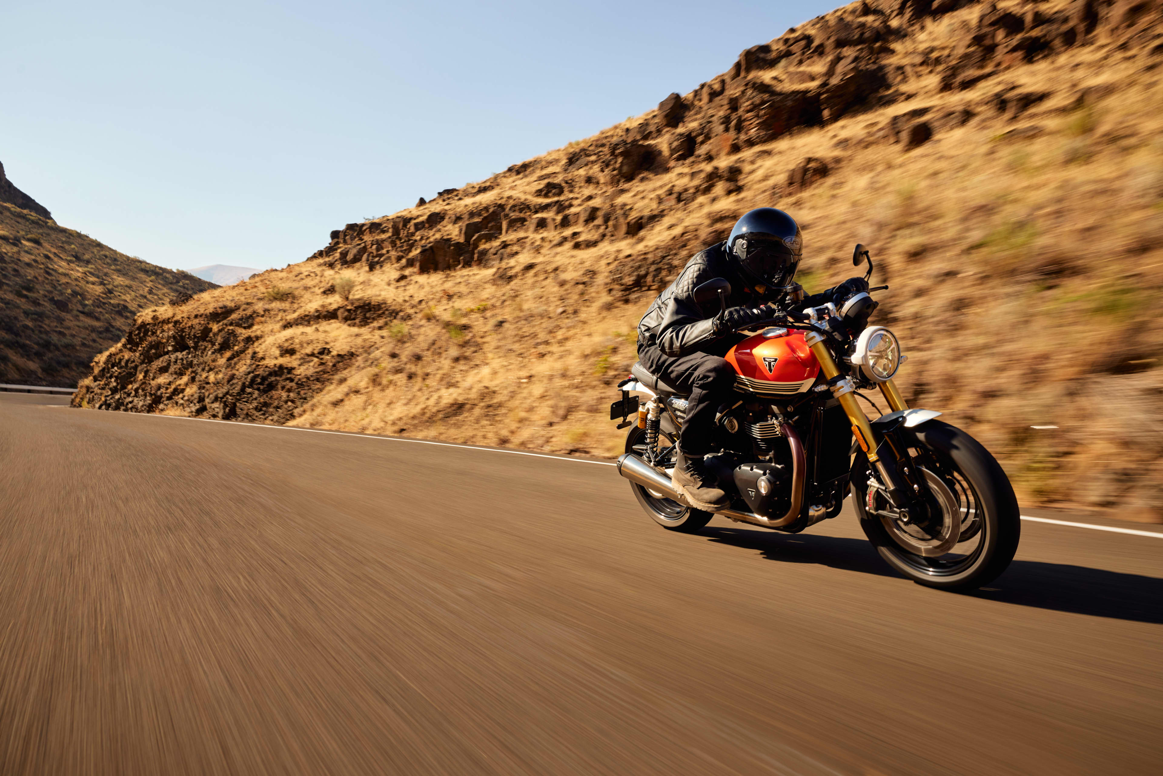 Angled side view riding shot of Triumph Speed Twin 1200 RS