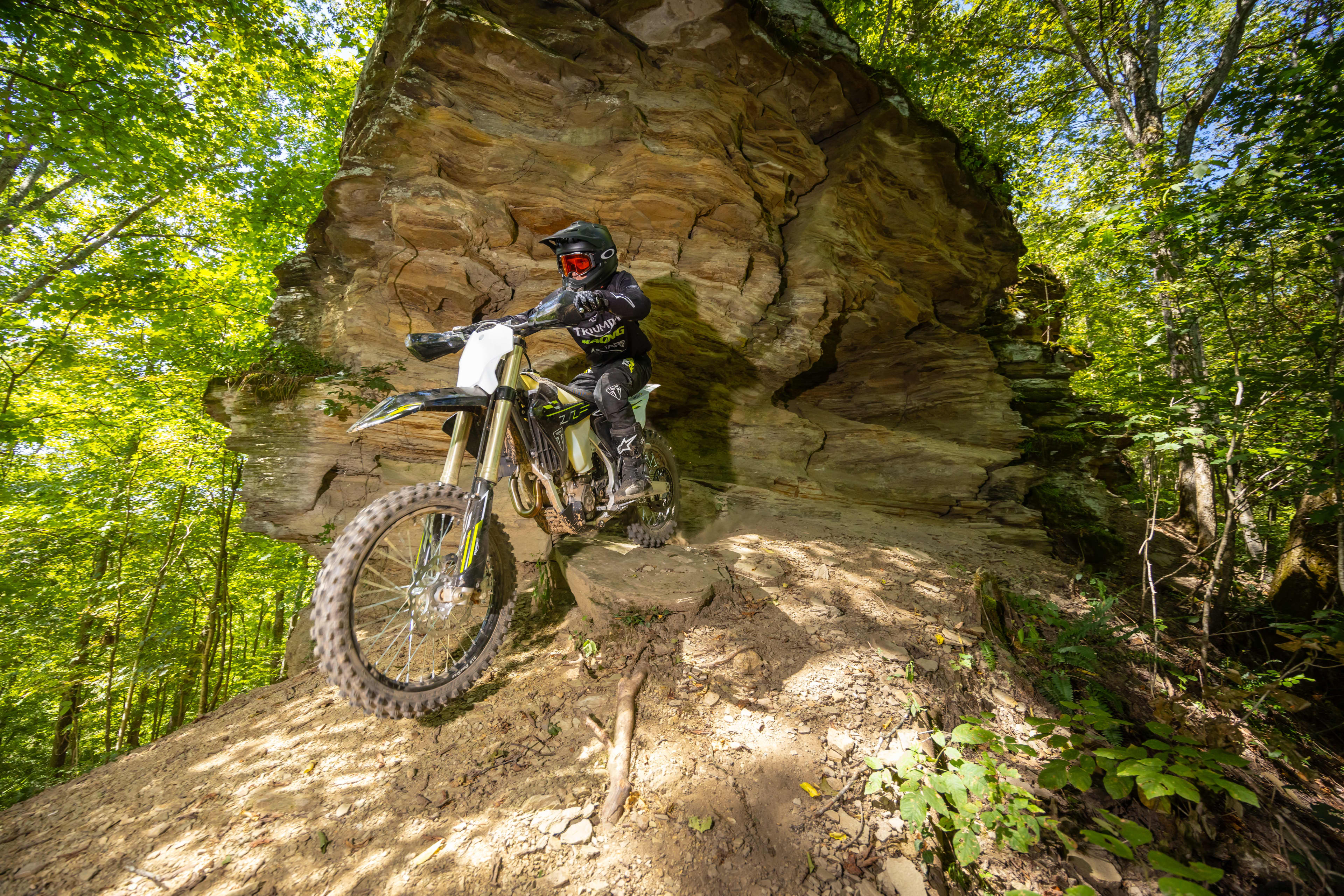 Triumph Cross Country motorcycle going down a rocky dirt hill