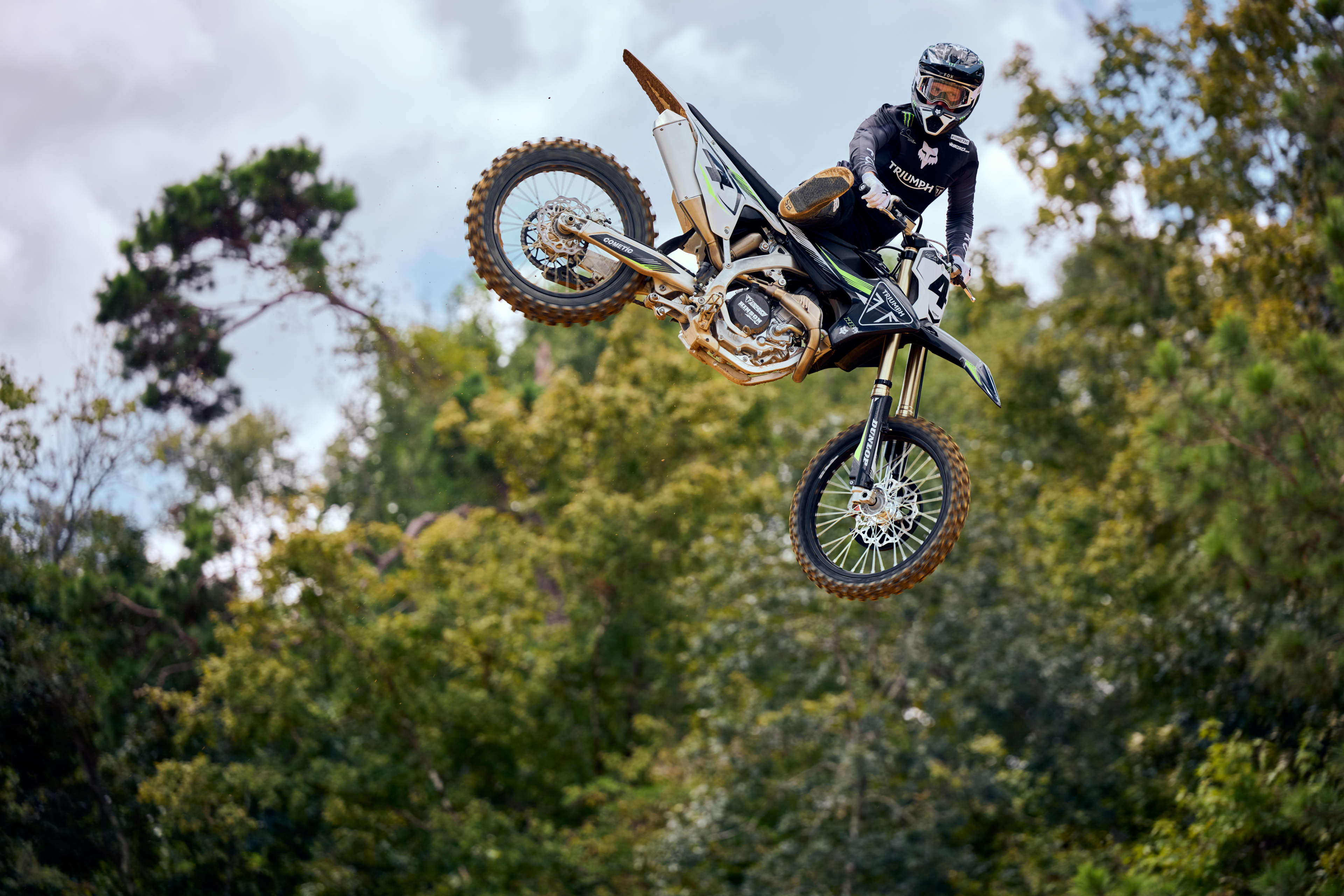TF 450 RC edition with stunt rider airborne on a forest backdrop