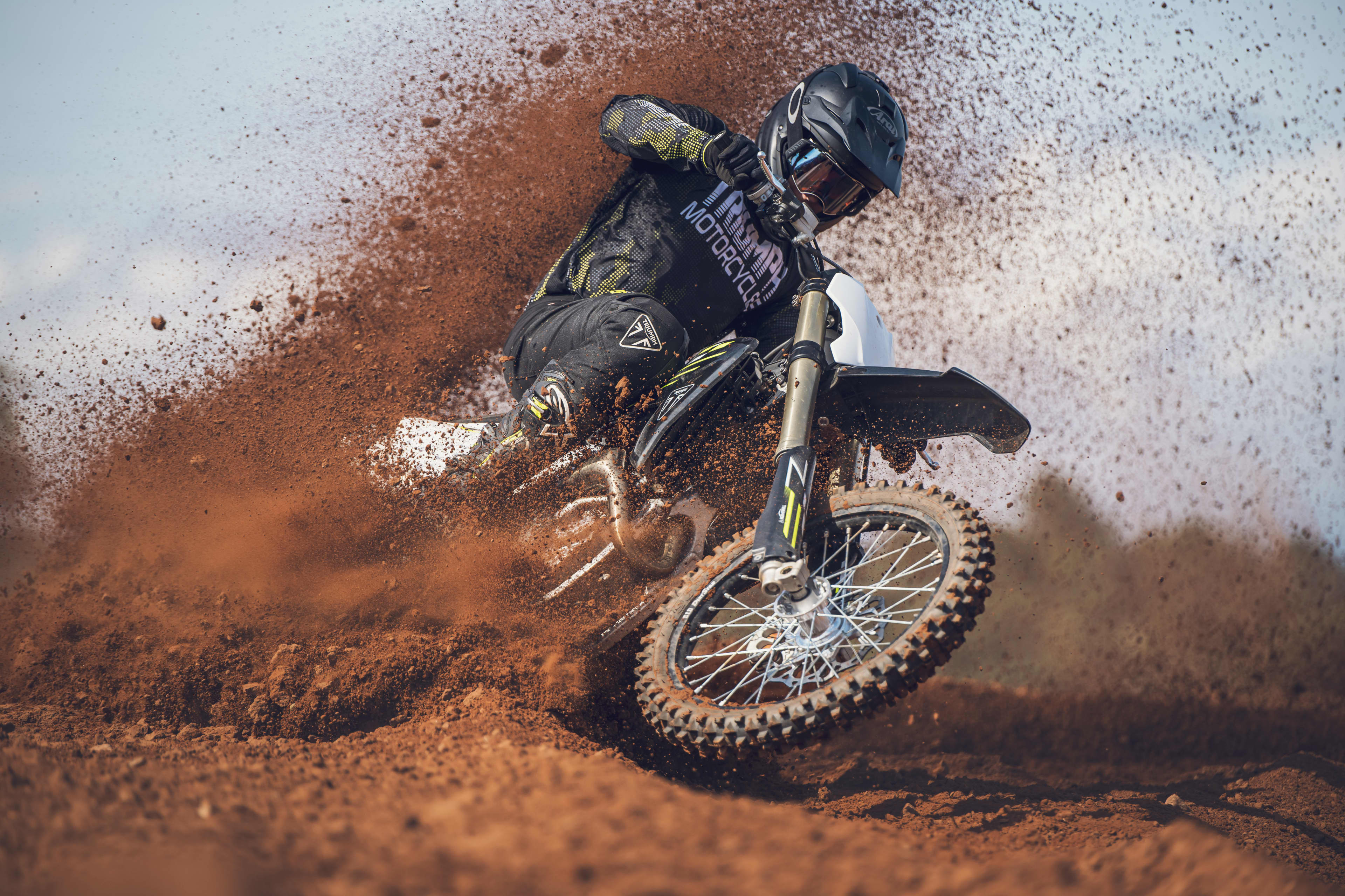 Rider on the Triumph TF 450-X riding through the extreme dirt motocross circuit