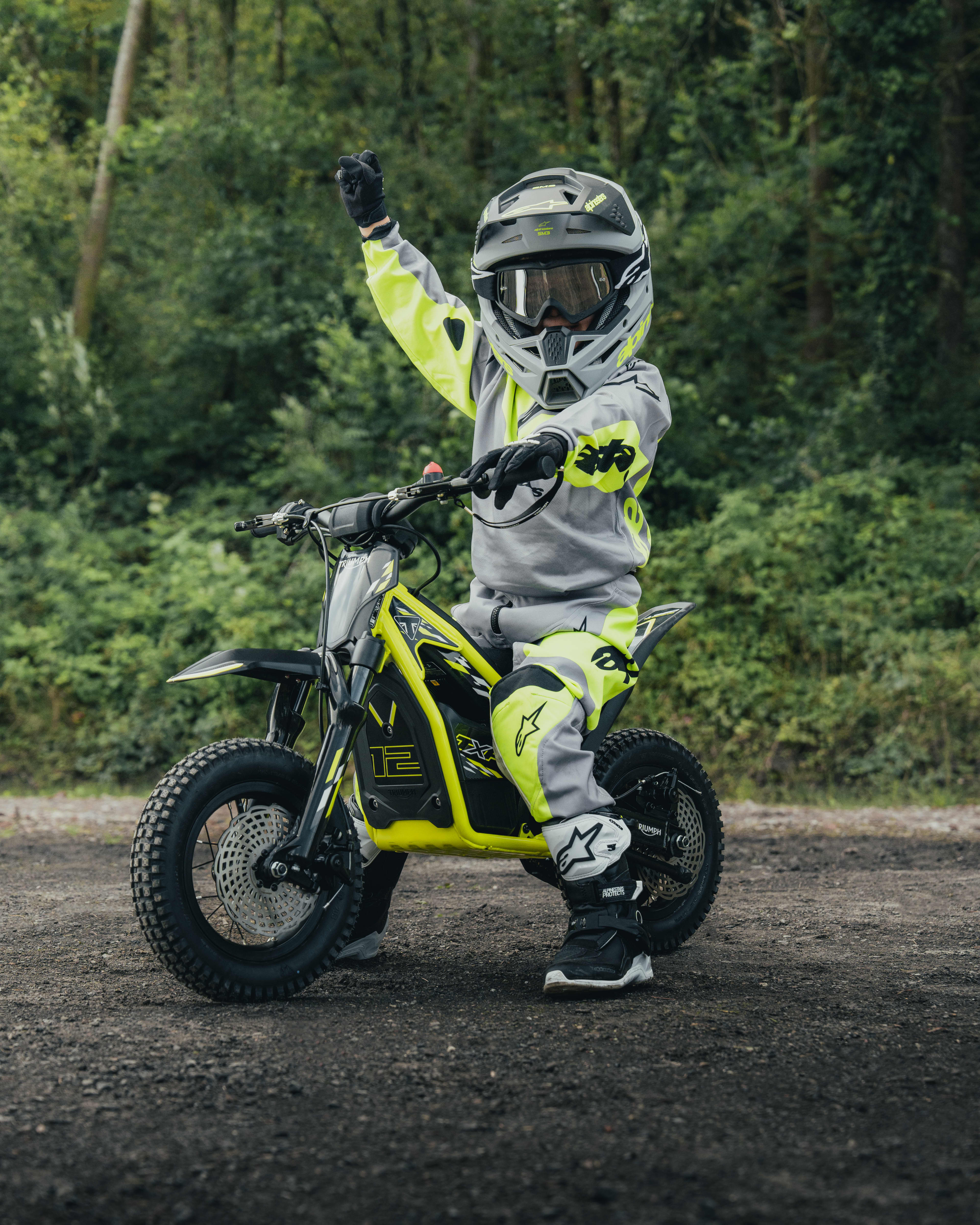 TXP-12 with the young rider on the bike showing a victory pose.
