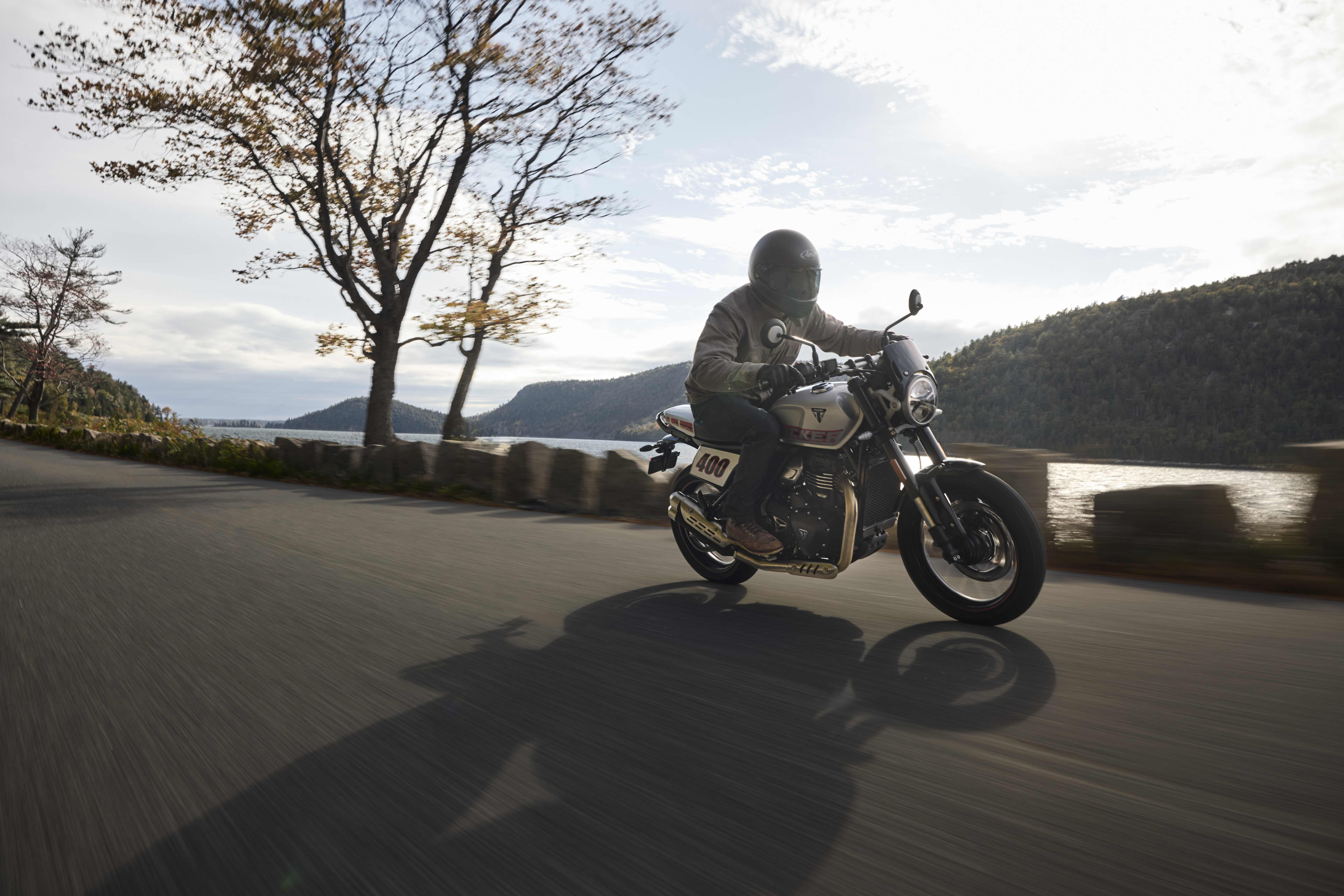 Ride side riding shot of Tracker 400 on a road along side a lake