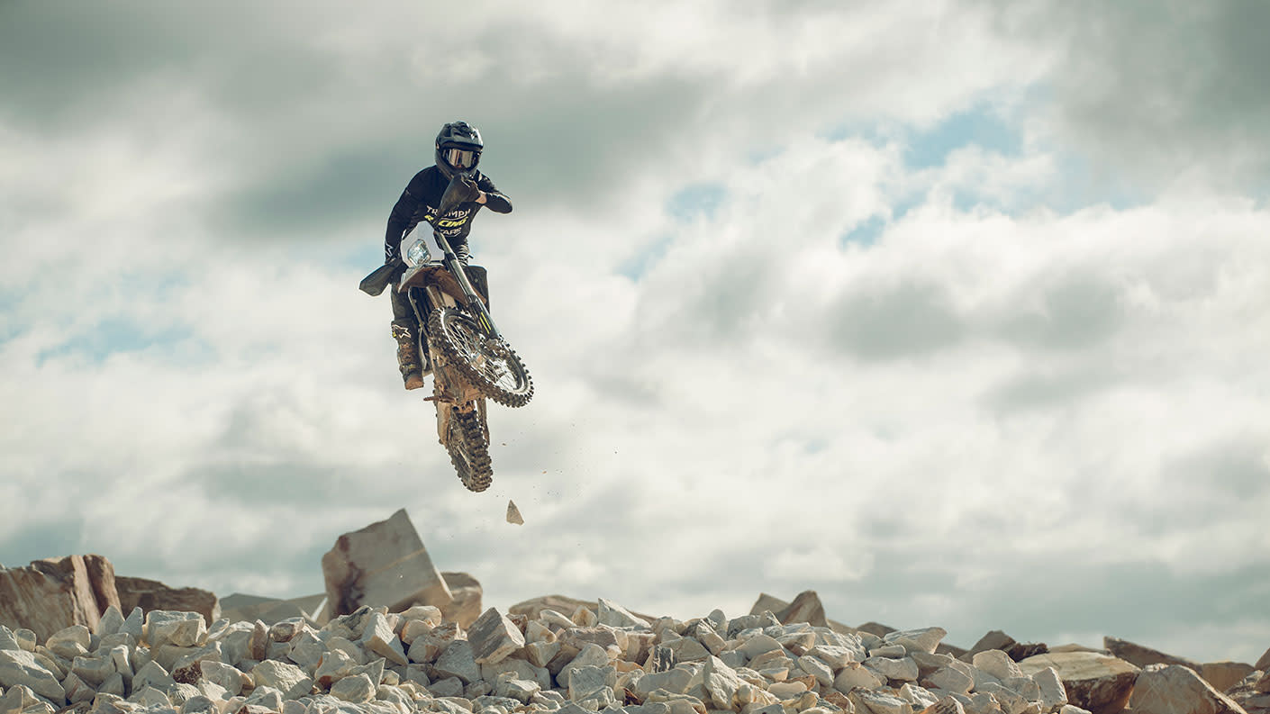 TF 250-E doing stunts over a rocky ground