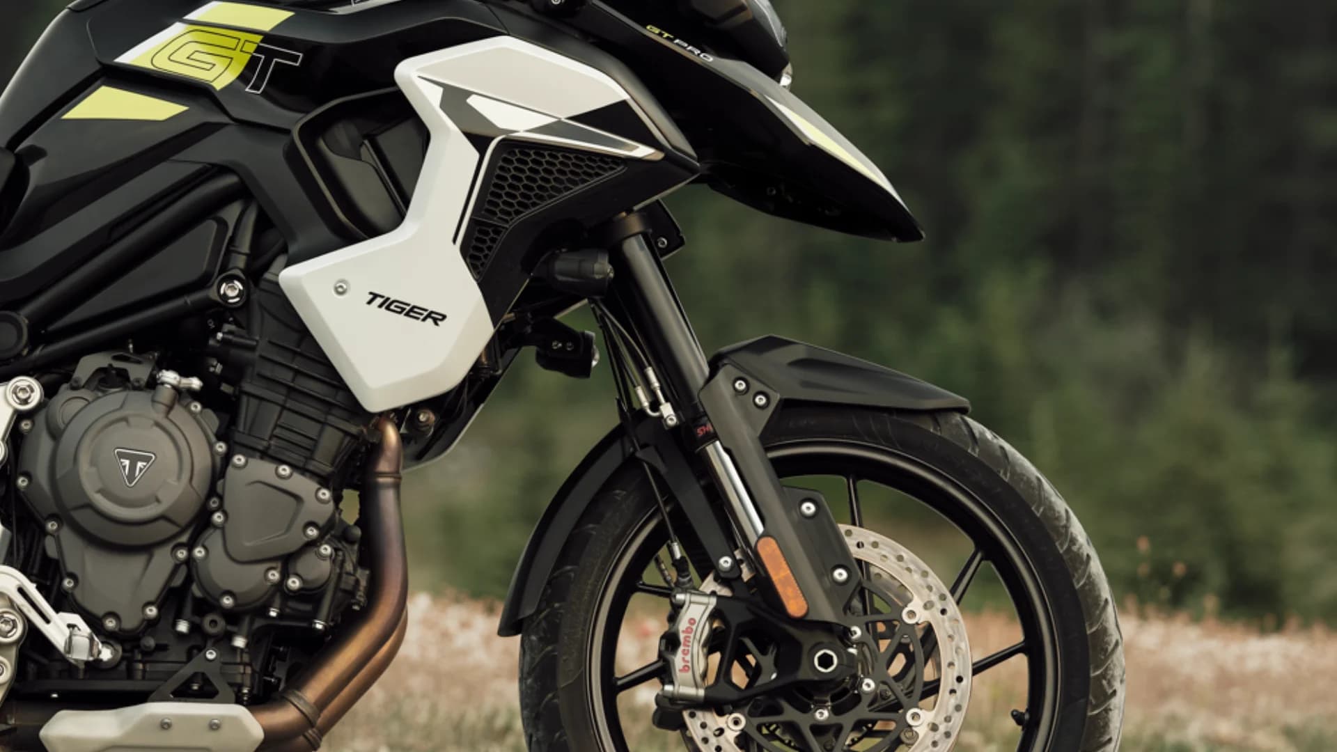 Detailed close-up shot of the front brake caliper, wheel, and fairing on a Triumph Tiger 1200 GT Pro motorcycle.