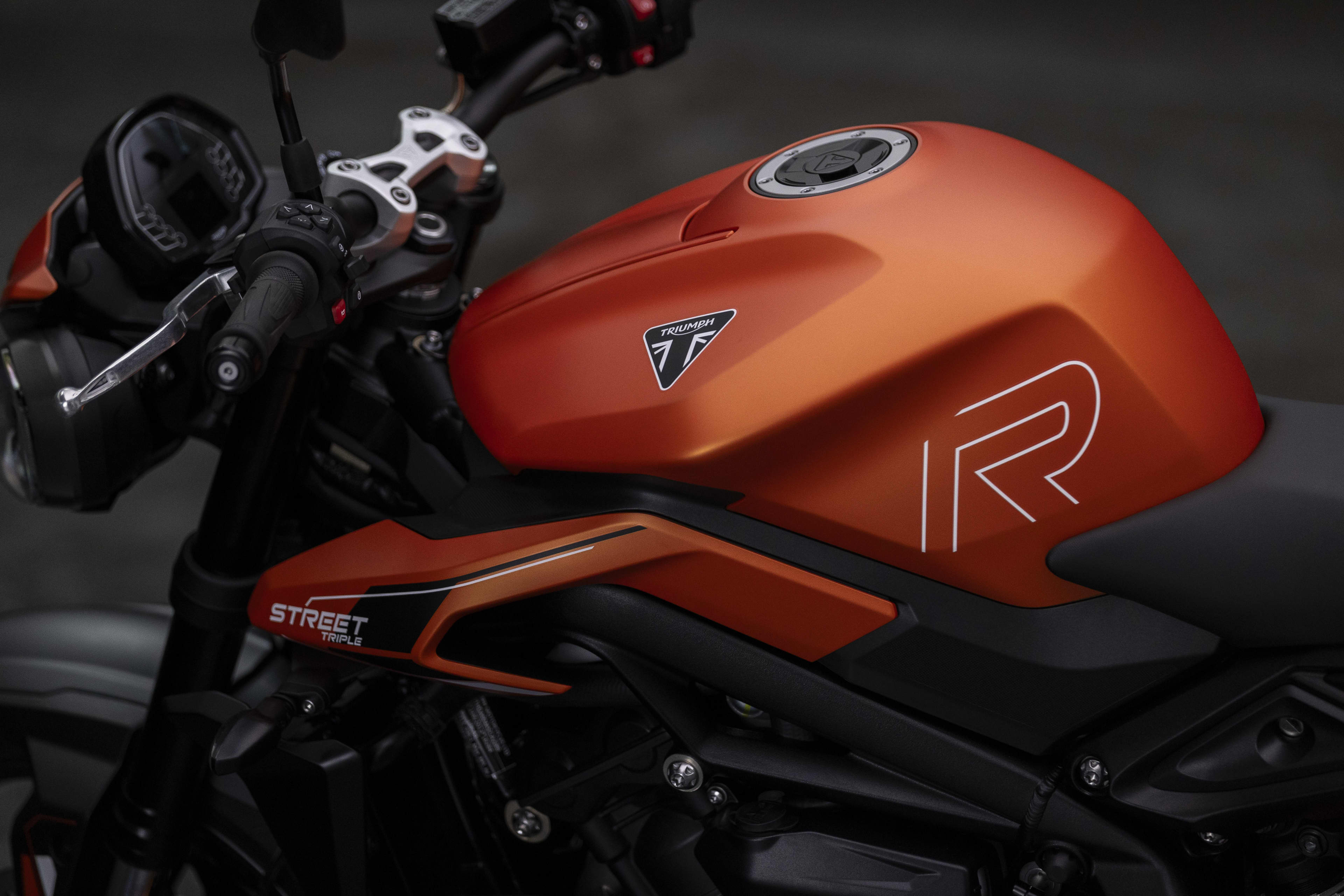 Side view close up shot of Roadster Triumph Street Triple 765 R A2 Matt Baja Orange