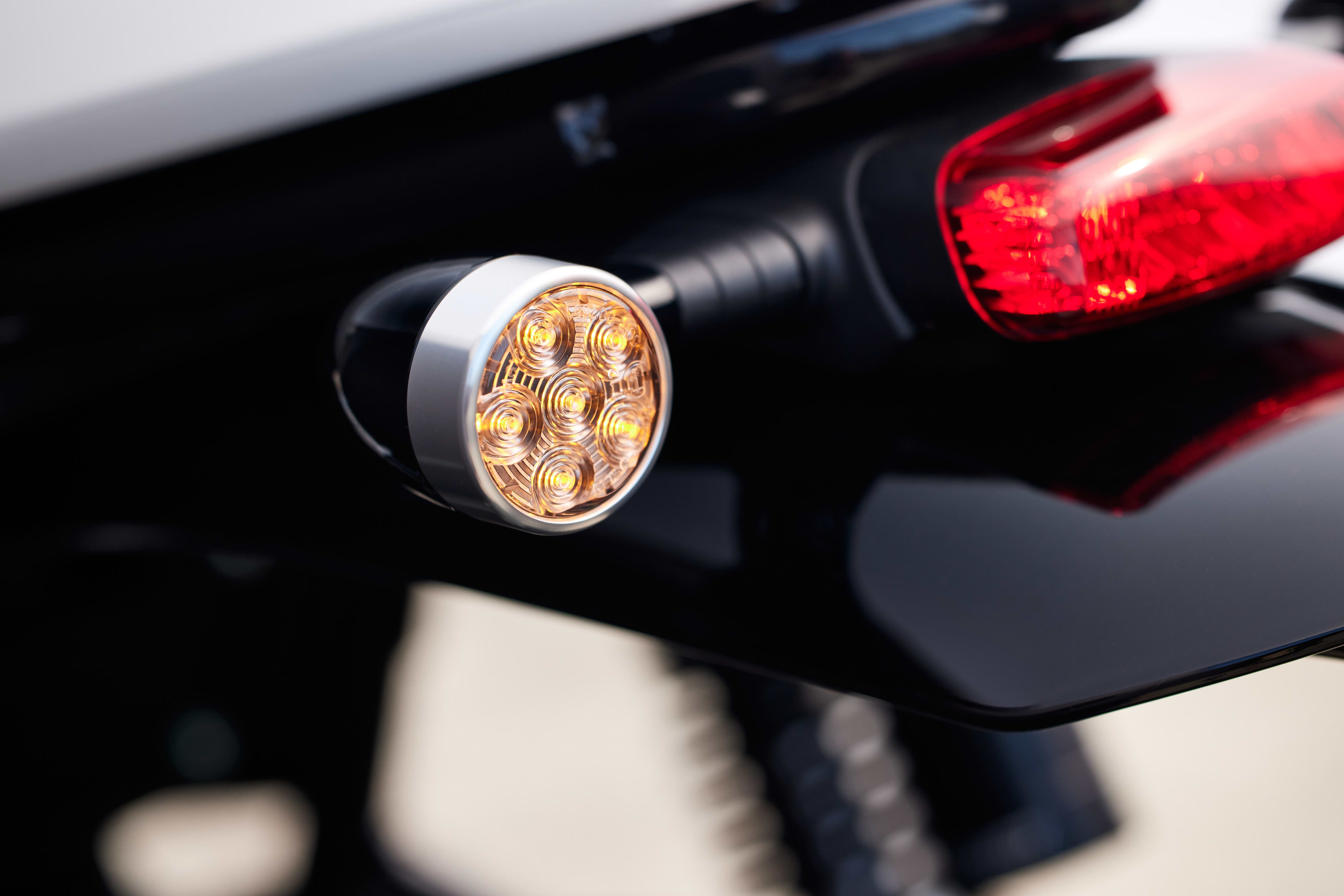 Close up shot of Triumph Speed Twin 1200 bullet-style front LED indicators with a turned aluminium bezel