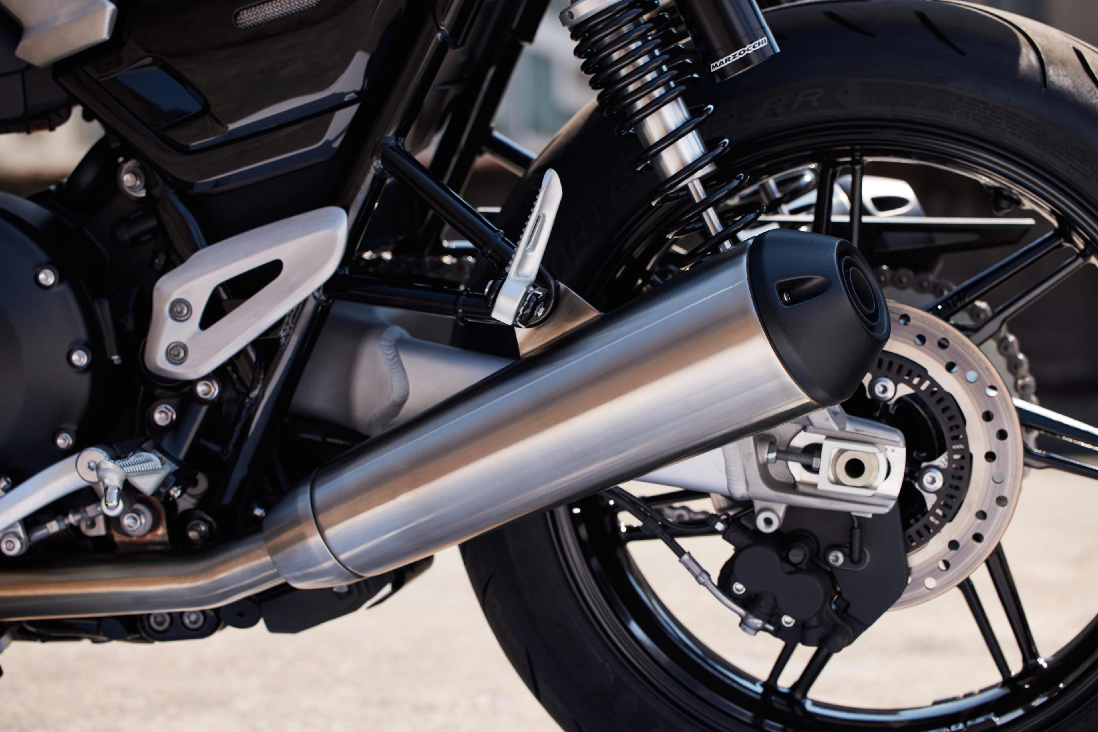 Close up of Triumph Speed Twin 1200 rear exhaust silencer and braking system