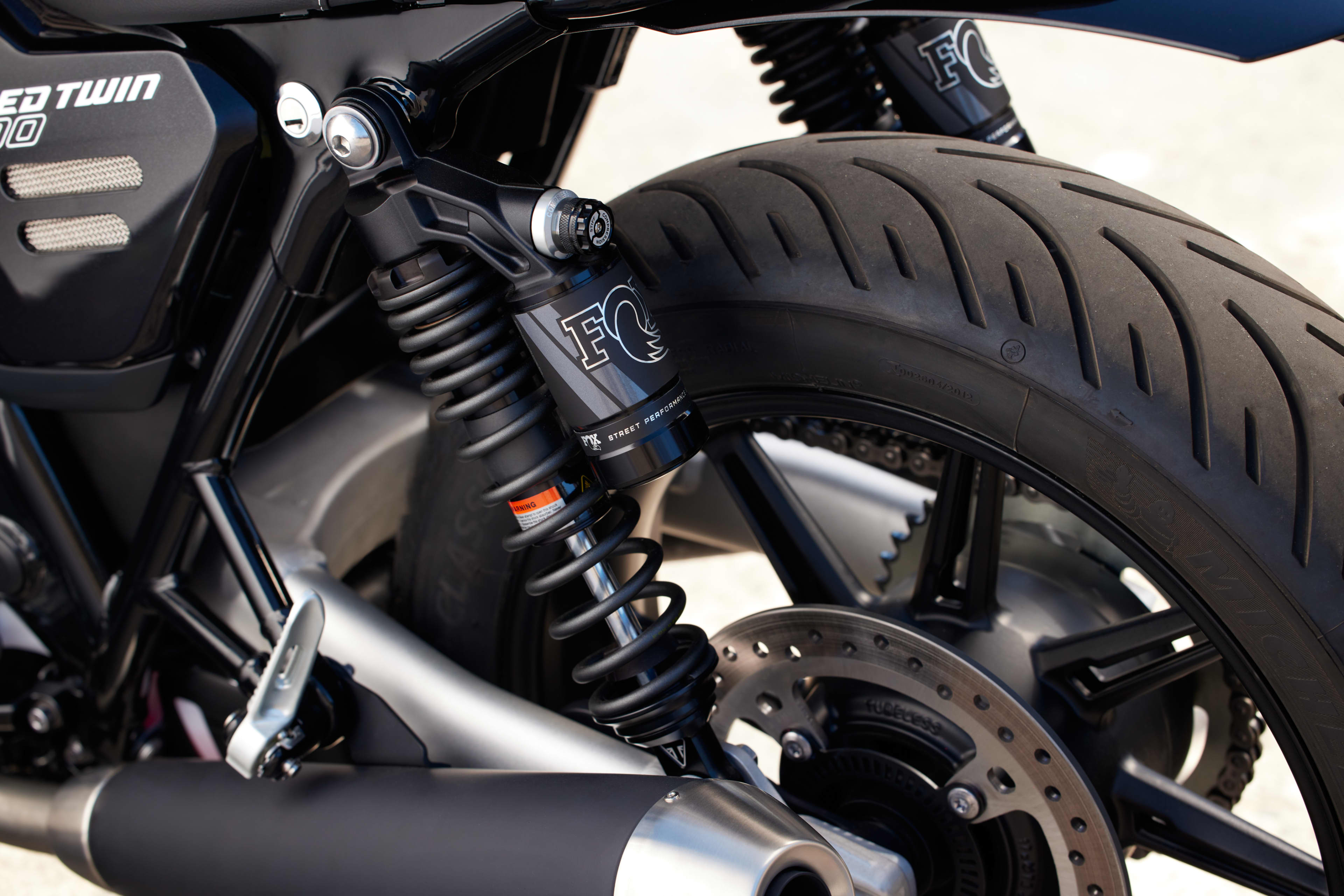 Close-up of the Speed Twin 900 rear suspension, wheel, and brake disc