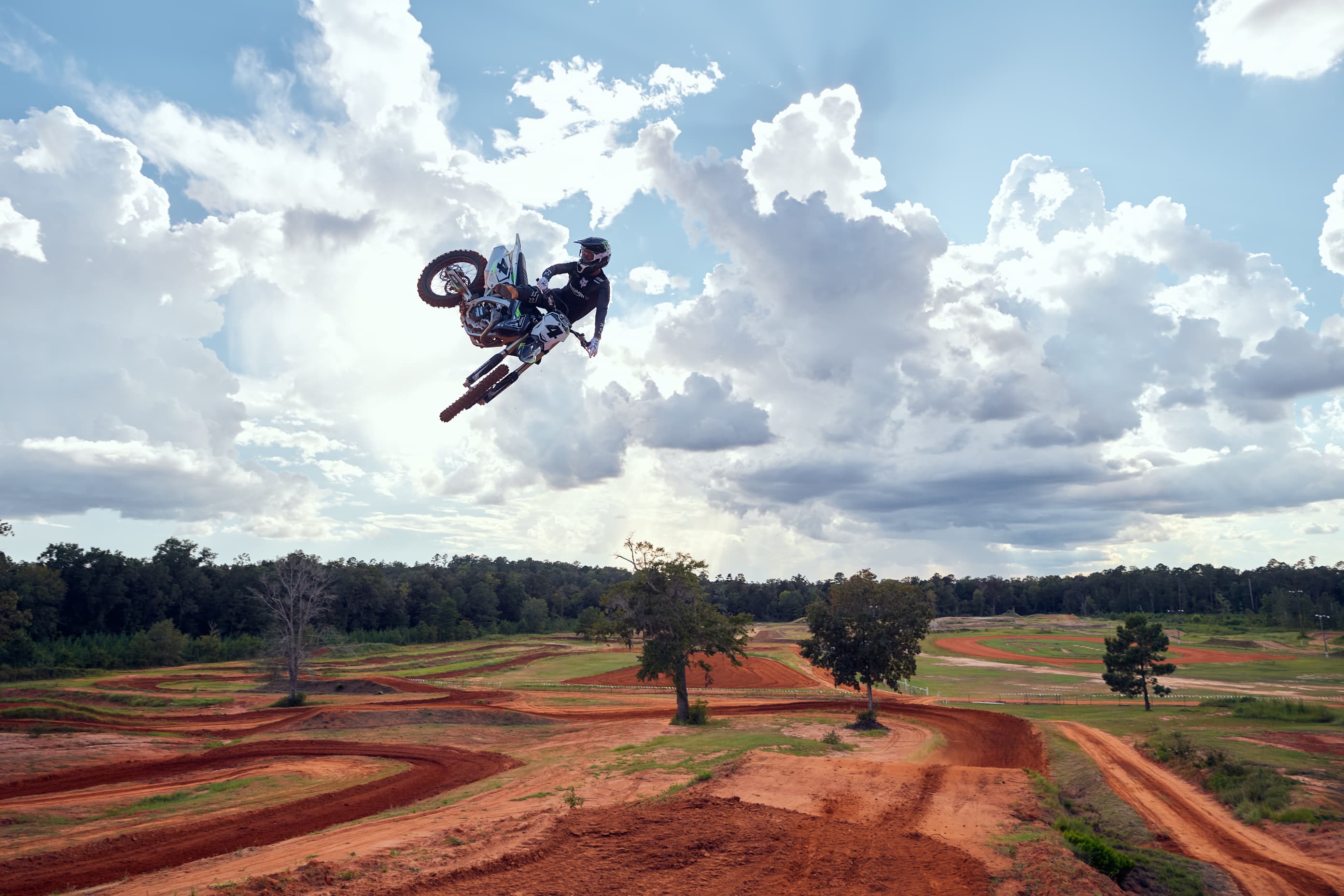 TF 450 RC edition with stunt rider airborne with a motocross circuit backdrop