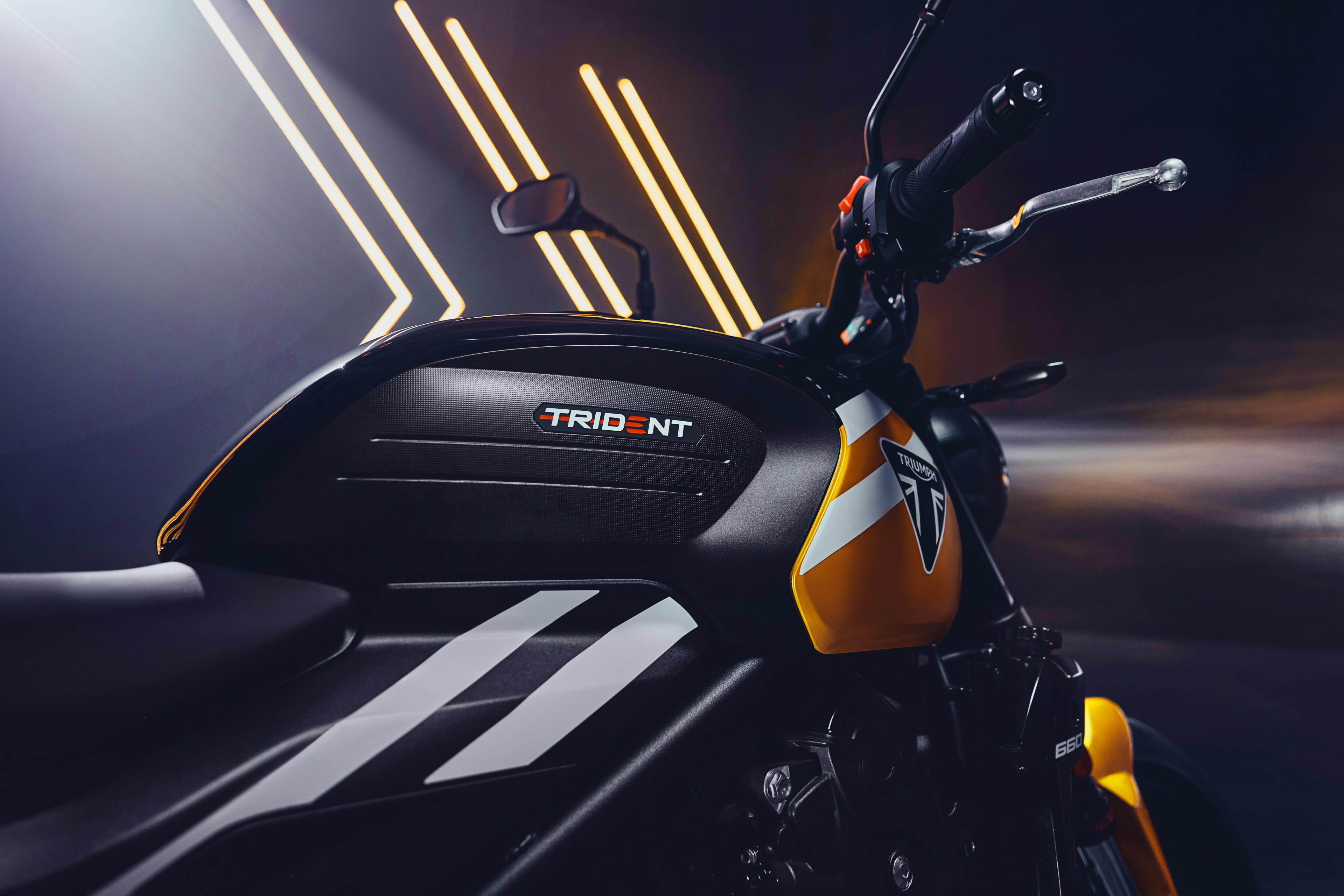 Triumph Trident 660 in Cosmic Yellow close up of Tank with studio spotlights