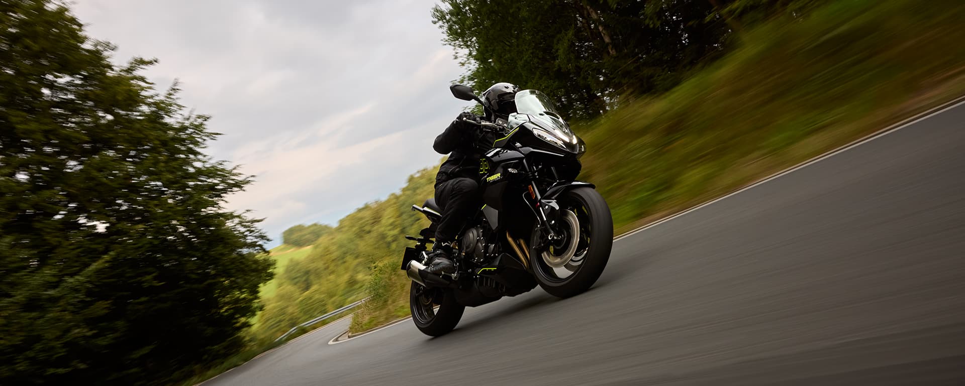 Right hand side of Tiger Sport 800 Tour parked on a road with nature in the background