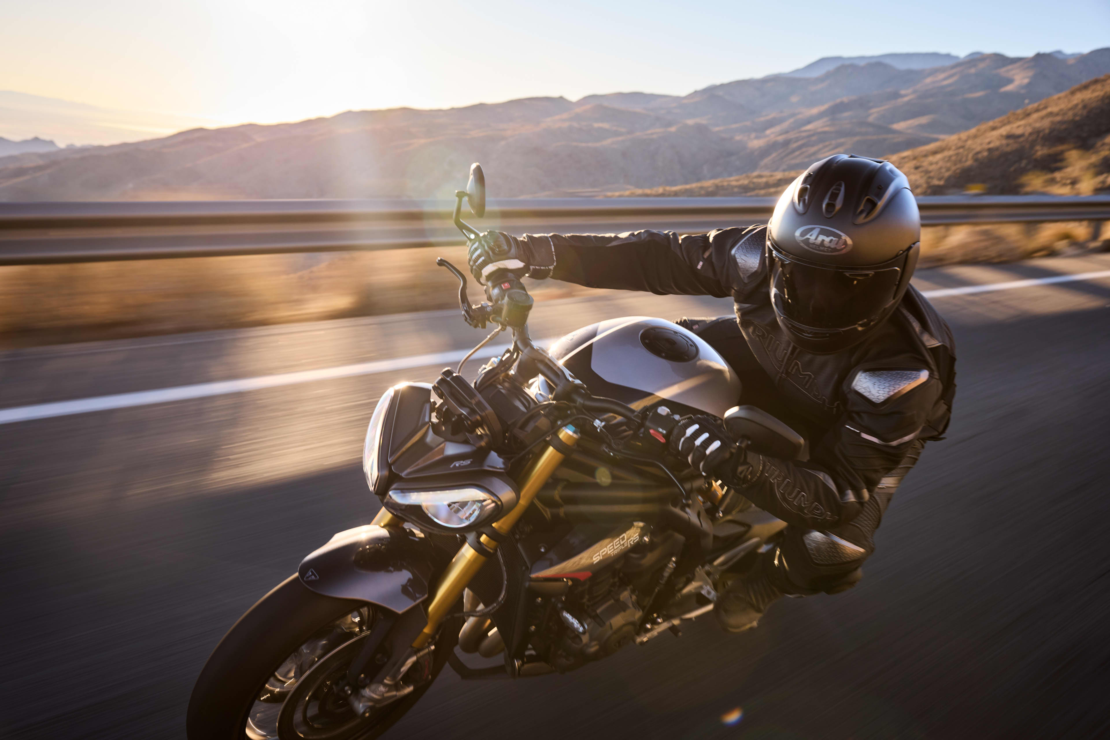 Speed Triple 1200 RS with a rider at sunrise