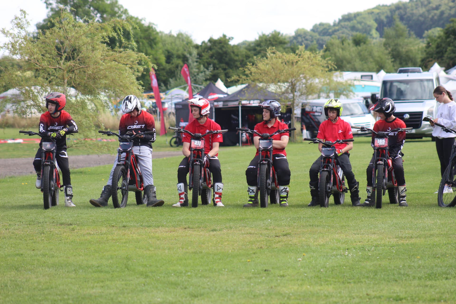 A group of young riders lined up at the experience centre waiting on instructions