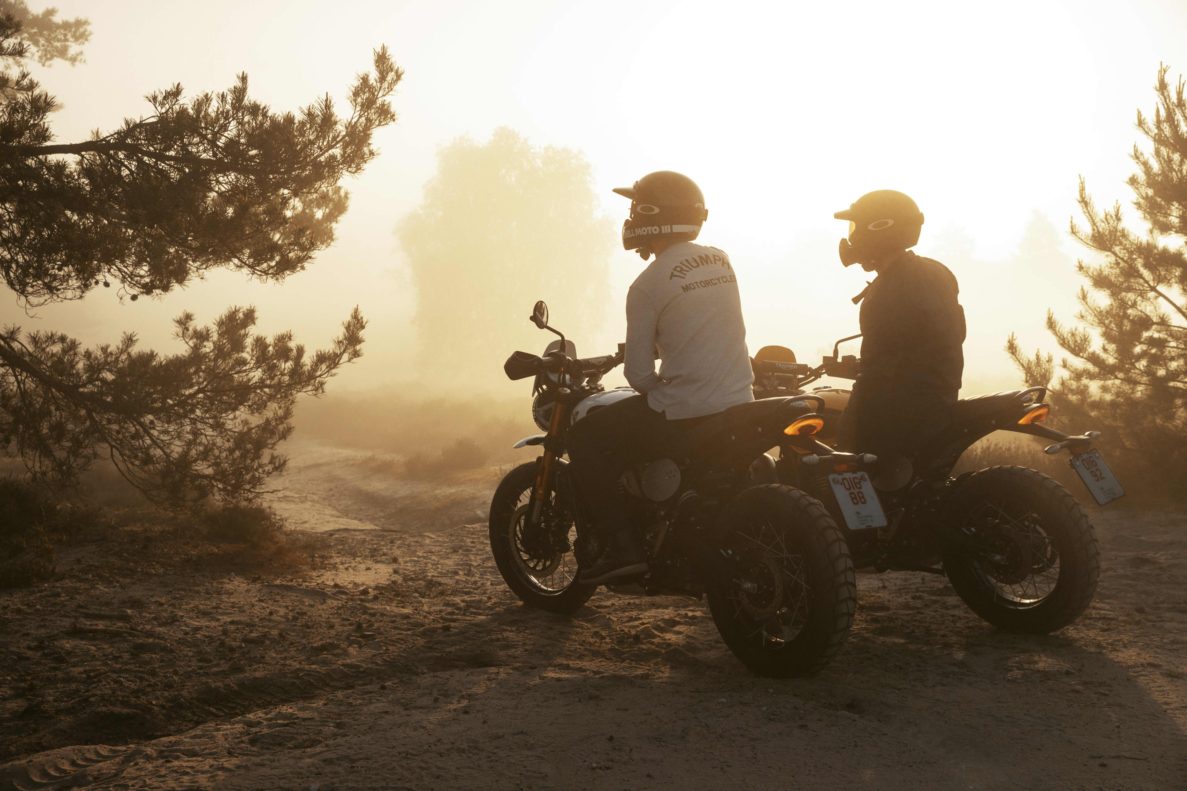 Scrambler 400 XC Triumph motorcycle atmospheric image with riders. 