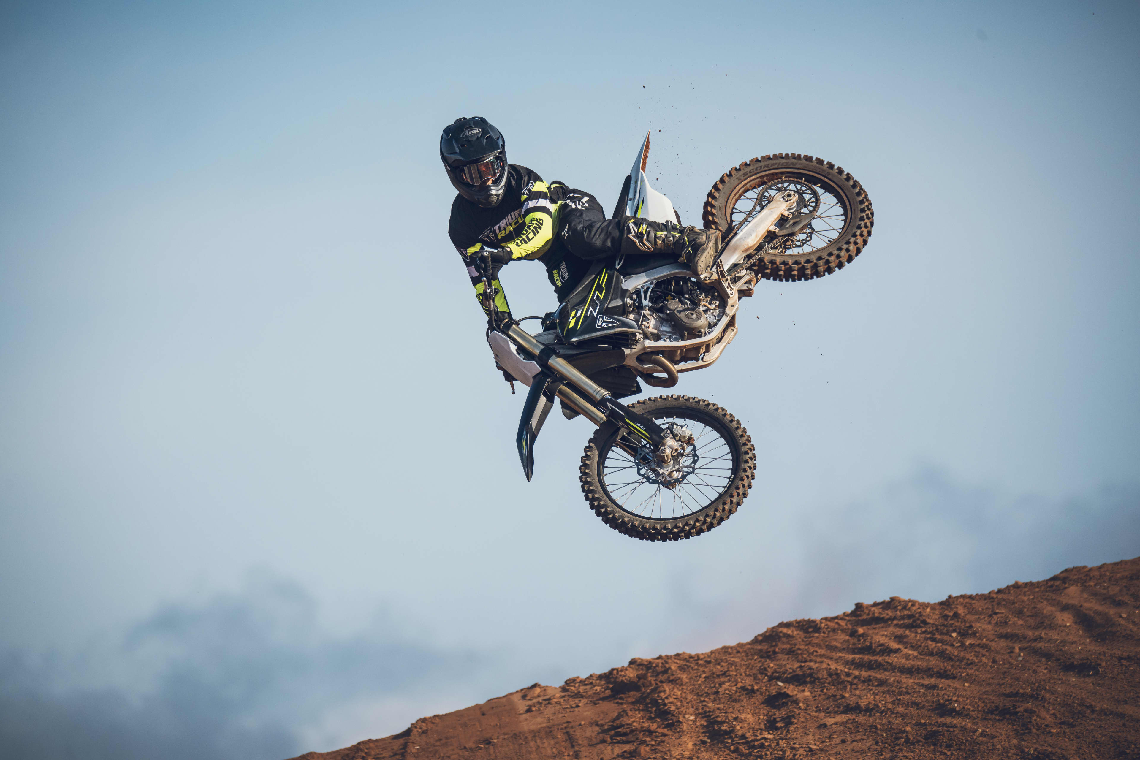 Triumph TF 450-X airborne with an advanced rider doing challenging tricks