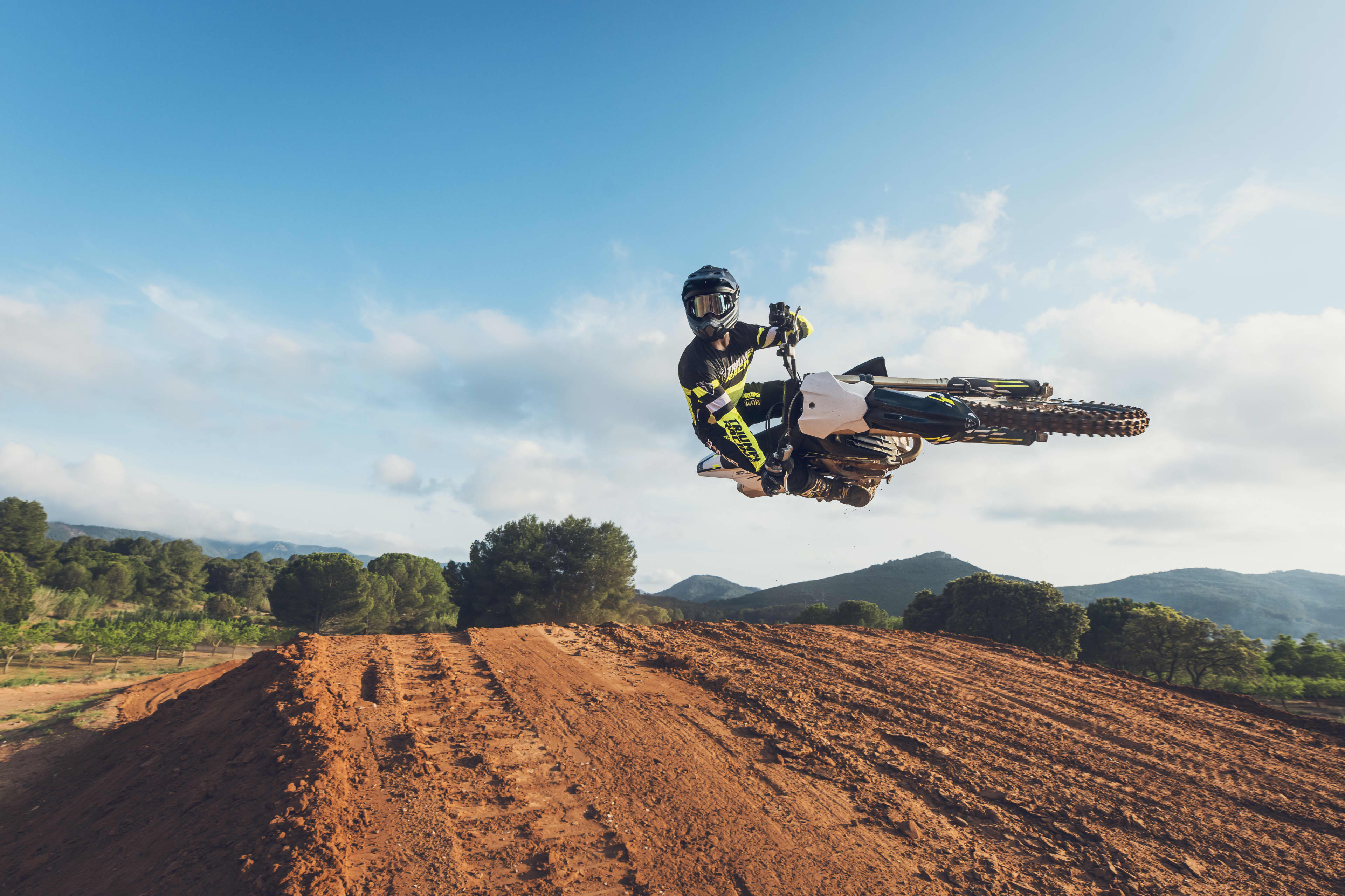 Rider on the Triumph TF 450-X getting an in-air shot of them doing a motorcycle trick