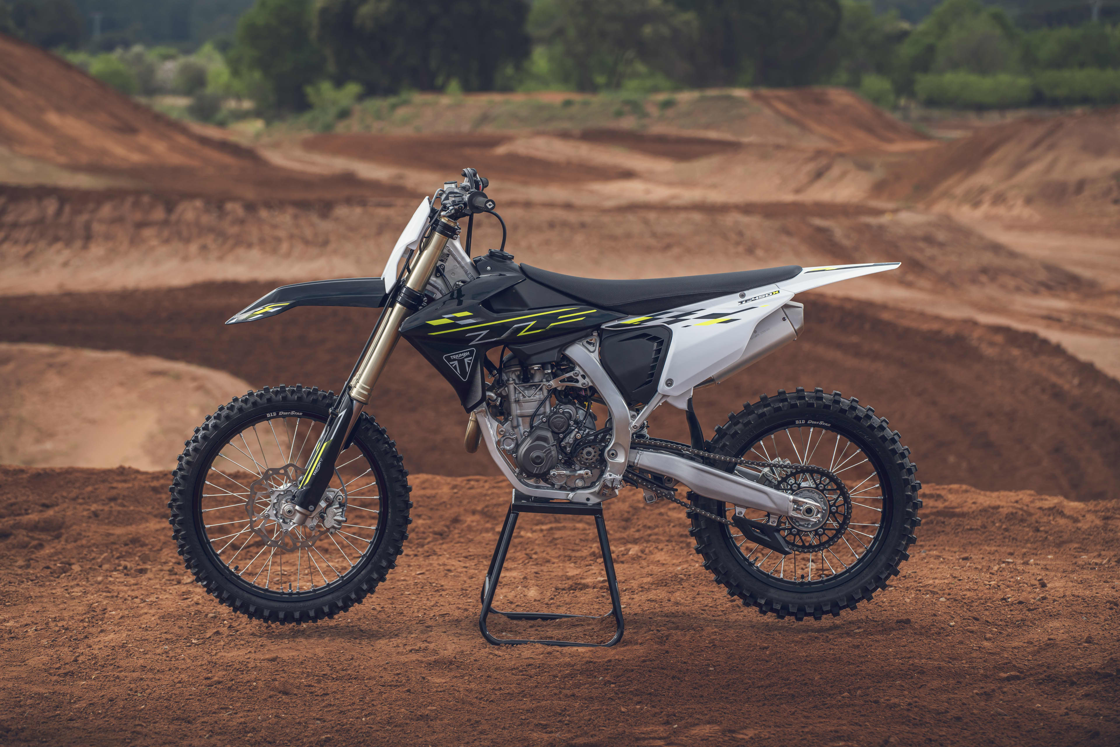 Triumph TF 450-X (MY26) left hand side view on a motocross landscape