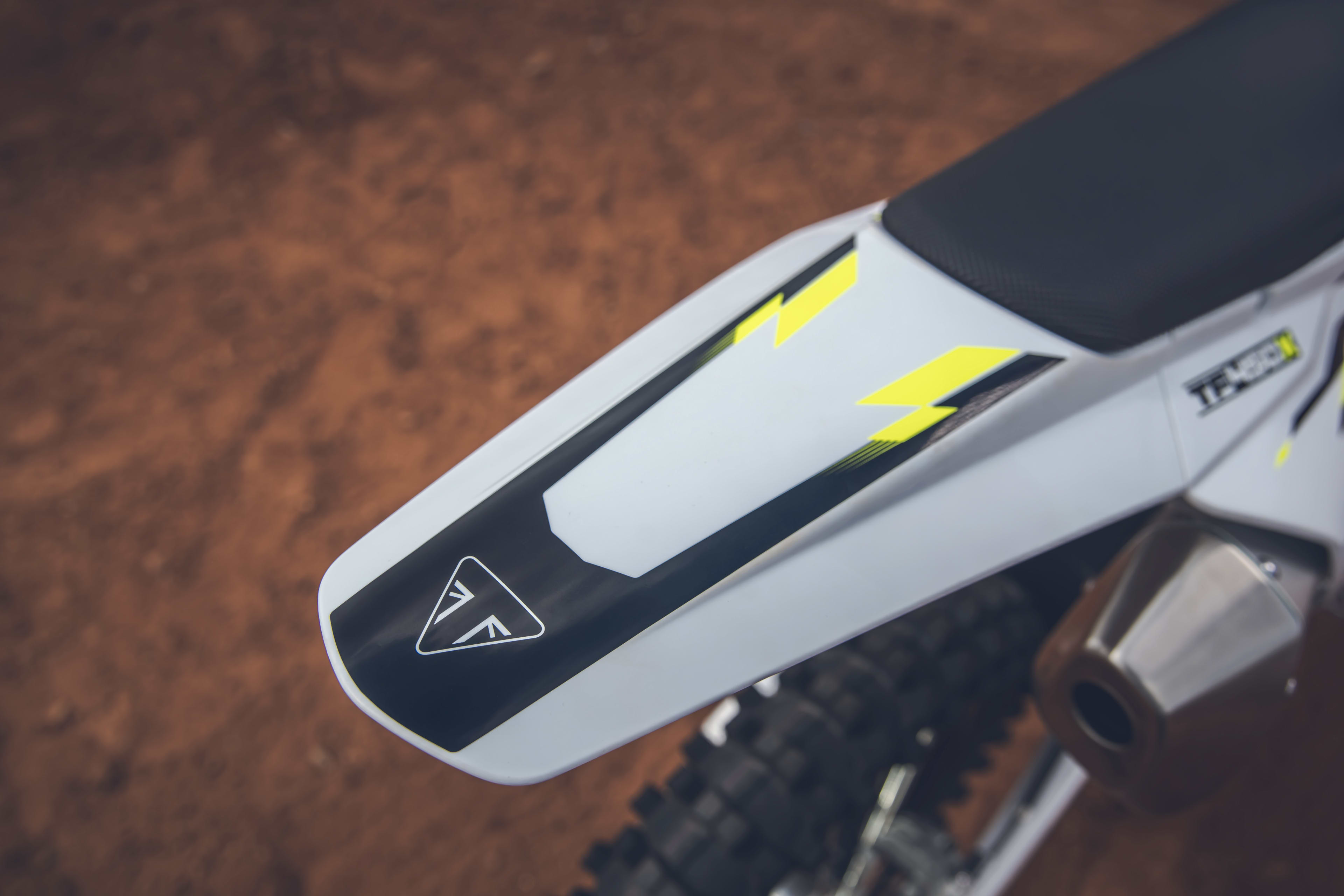 Close up of the Triumph TF 450-X logo on the rear end of the bike