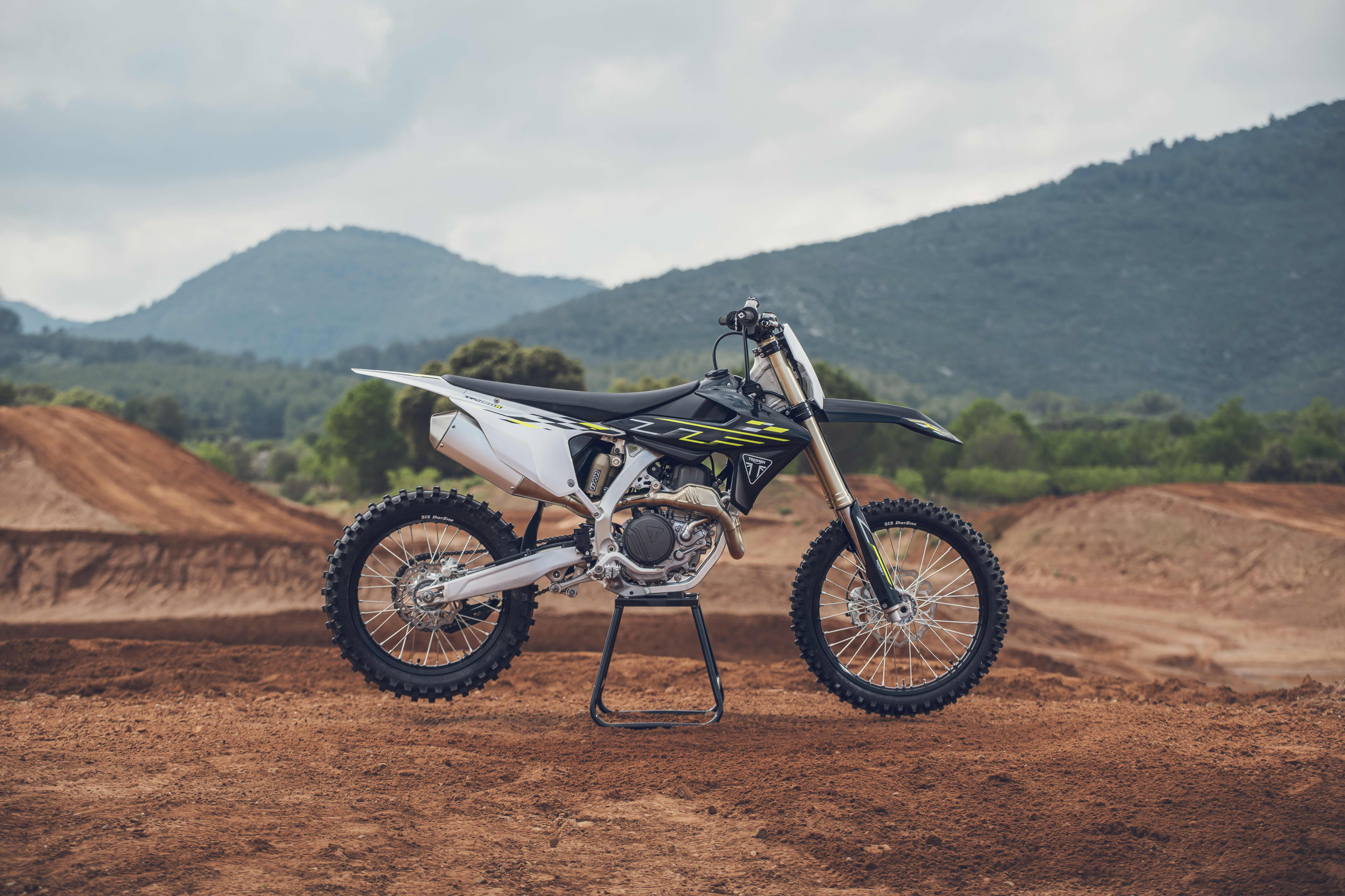 TF 450-X static shot of the motorcycle parked up on stand at the red dirt track