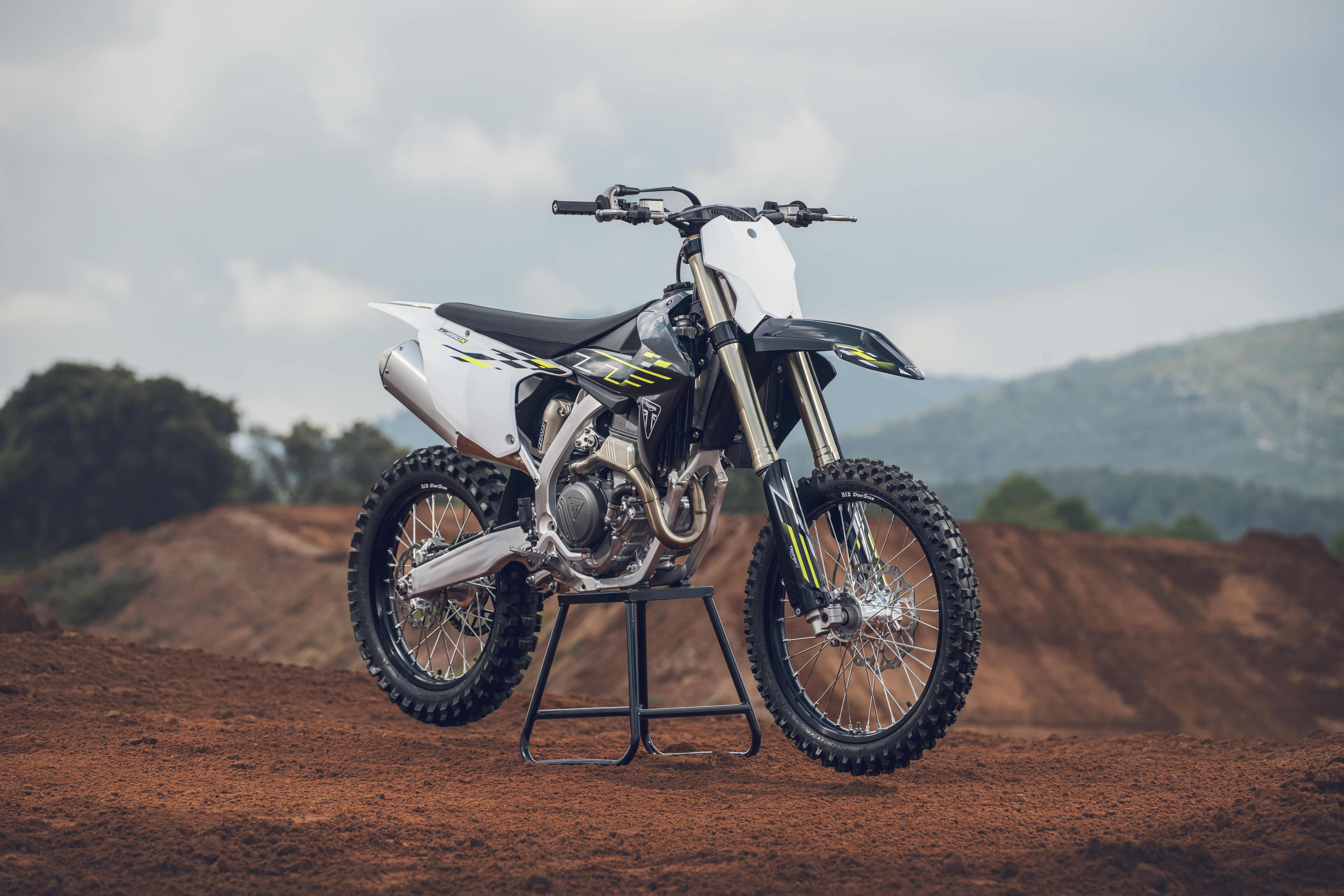 Triumph TF 250-X (MY26) side angle in a motocross landscape