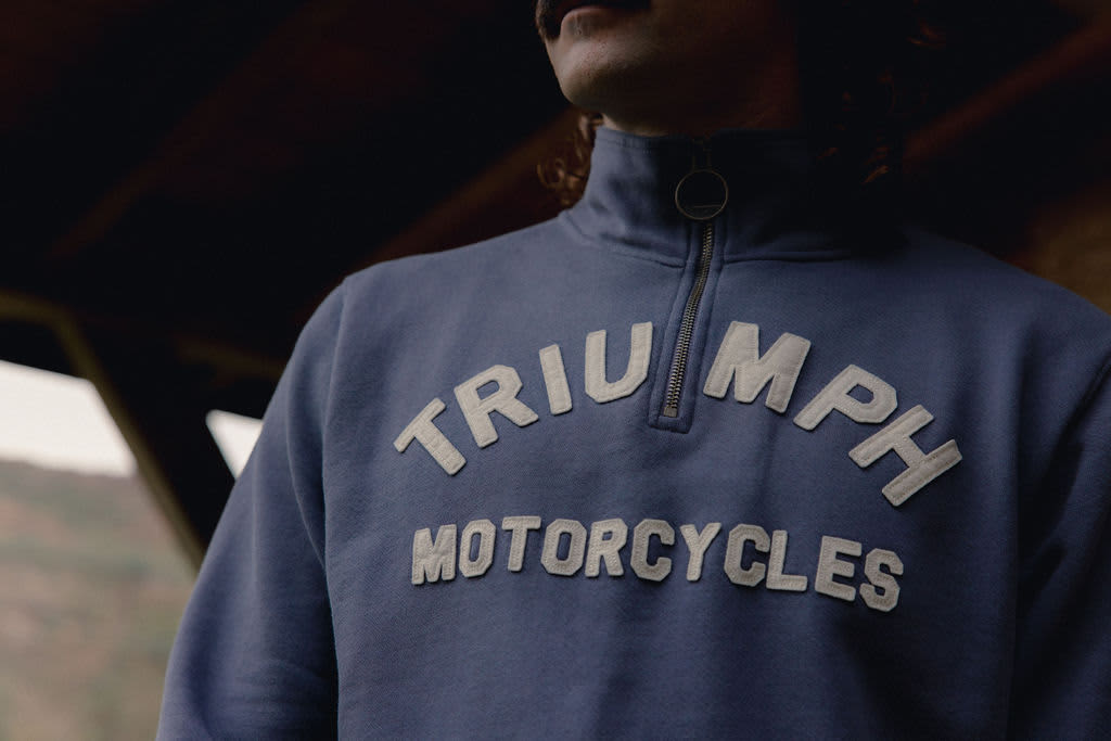 Close up of a man wearing a Triumph Motorcycles Blue Sweatshirt