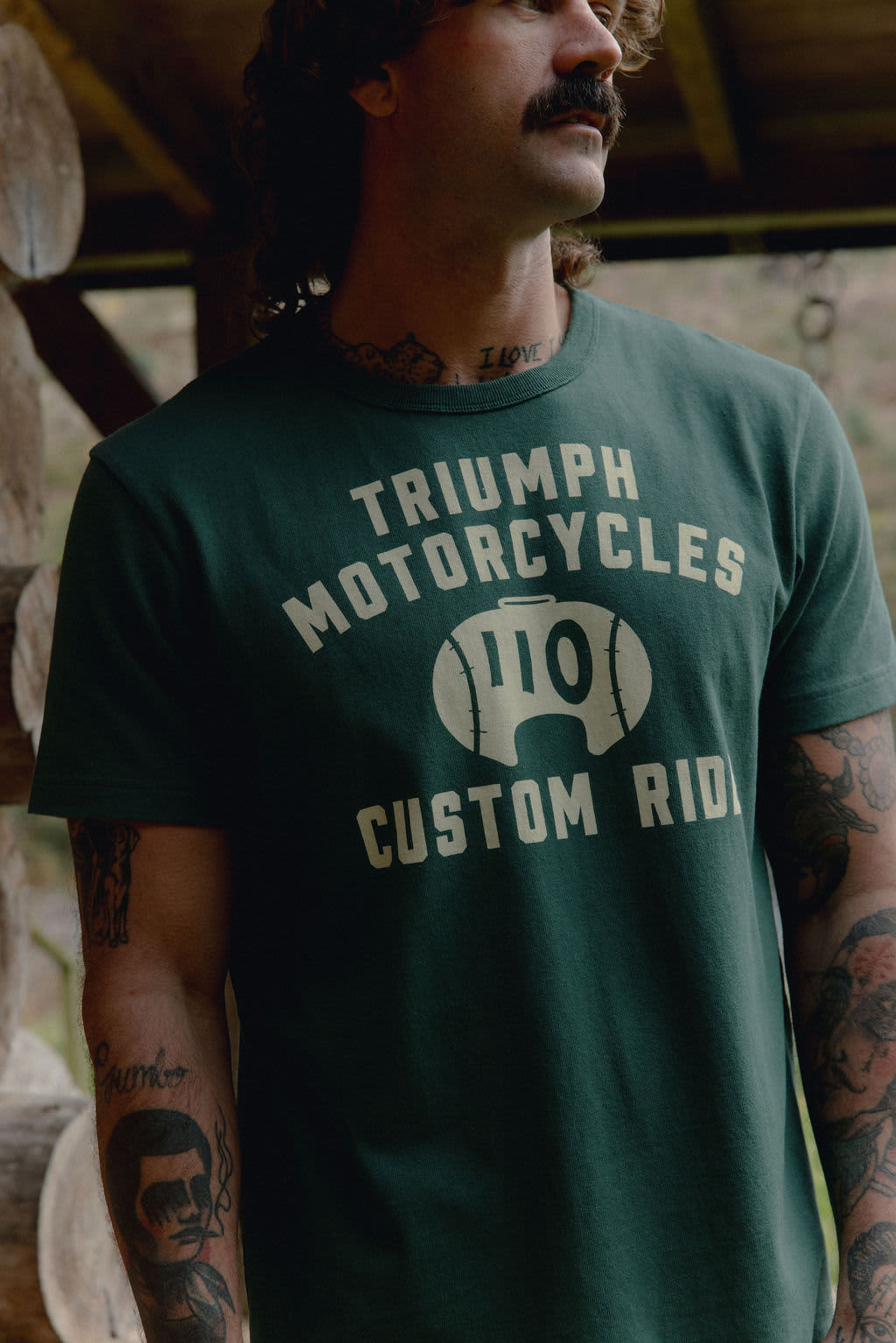 Close up of man wearing a Triumph Motorcycles Custom Ride T-shirt in green