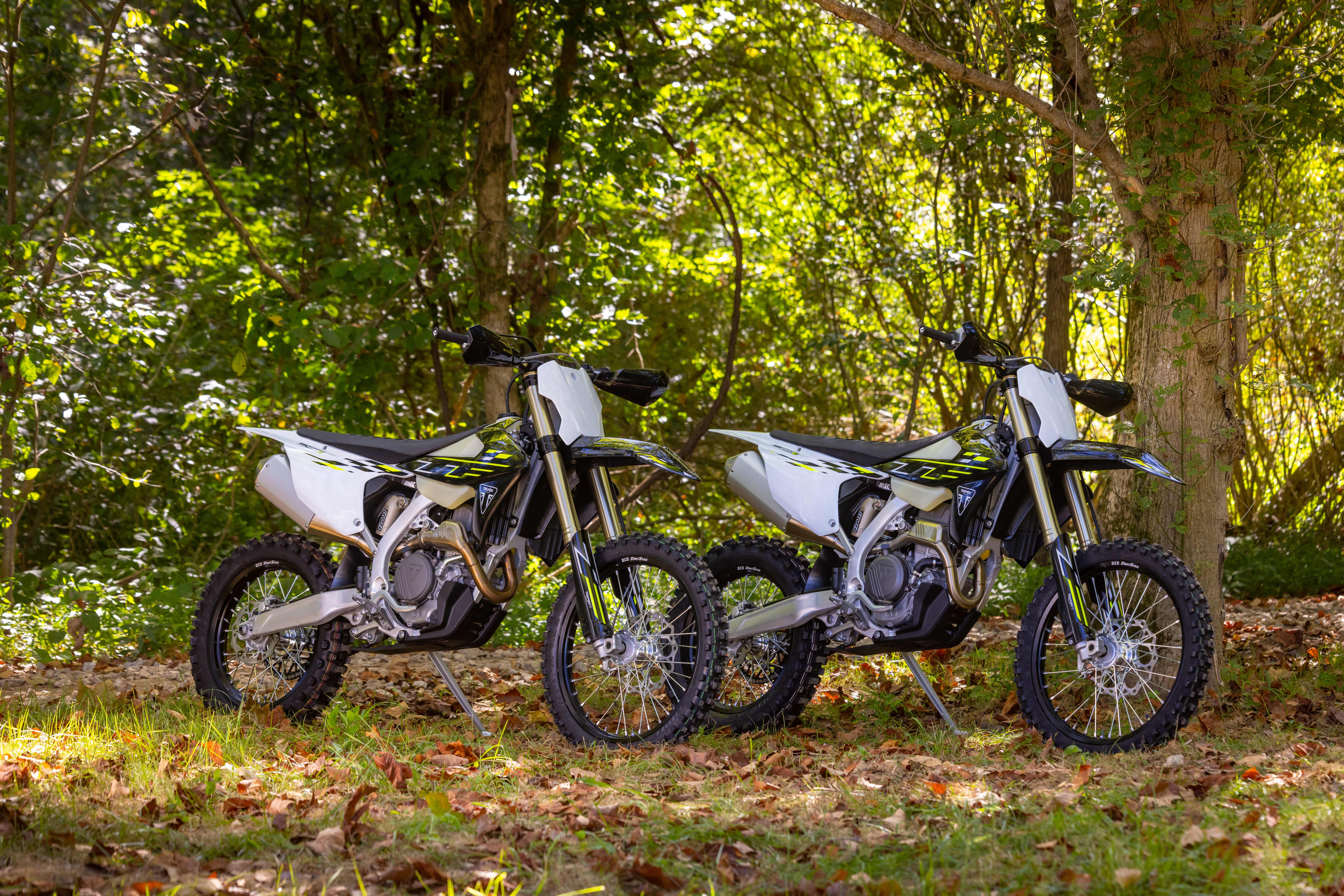 Triumph Cross Country motorcycles parked up with a forest backdrop