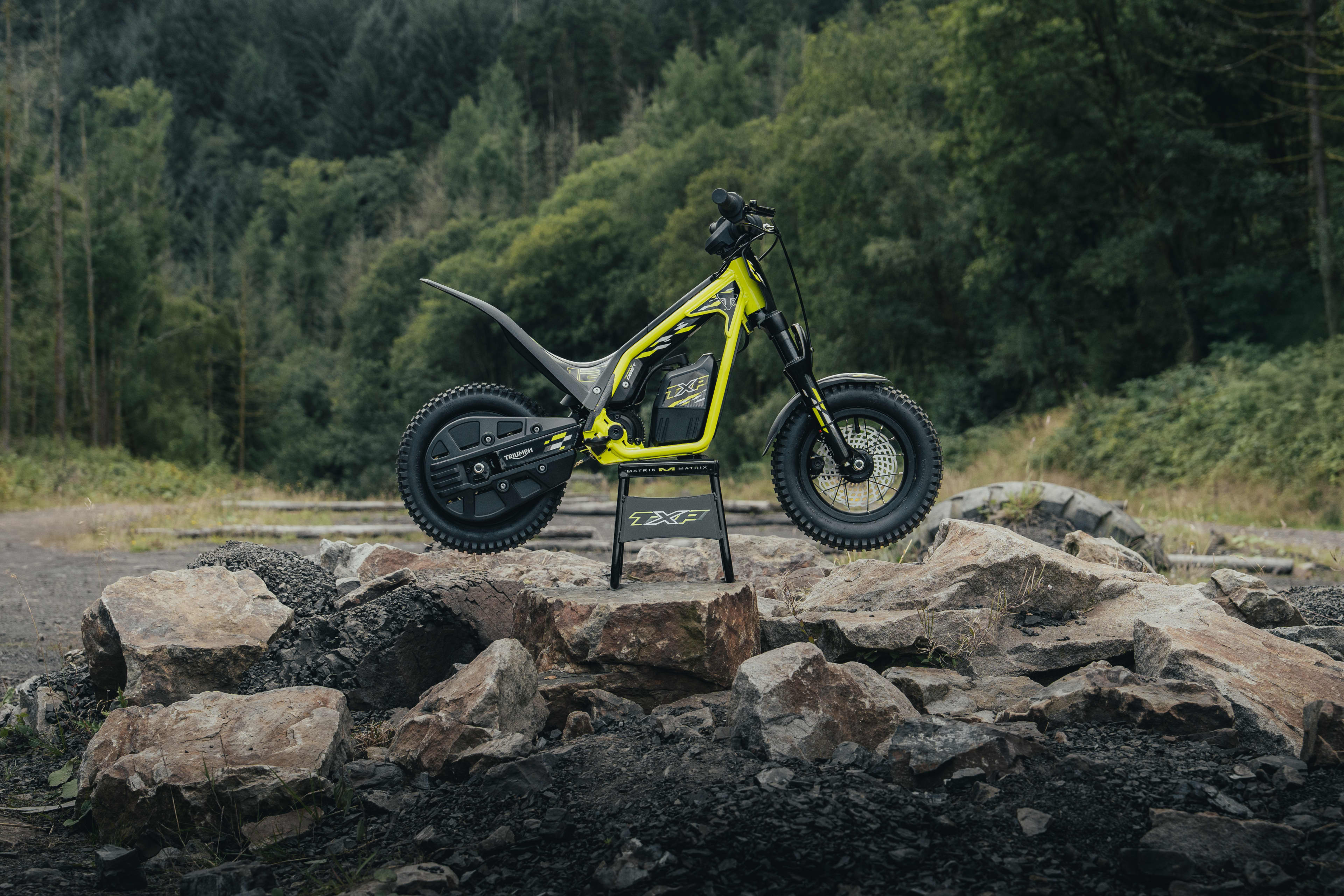 TXP-12 electric bike parked up on the rocky terrain.
