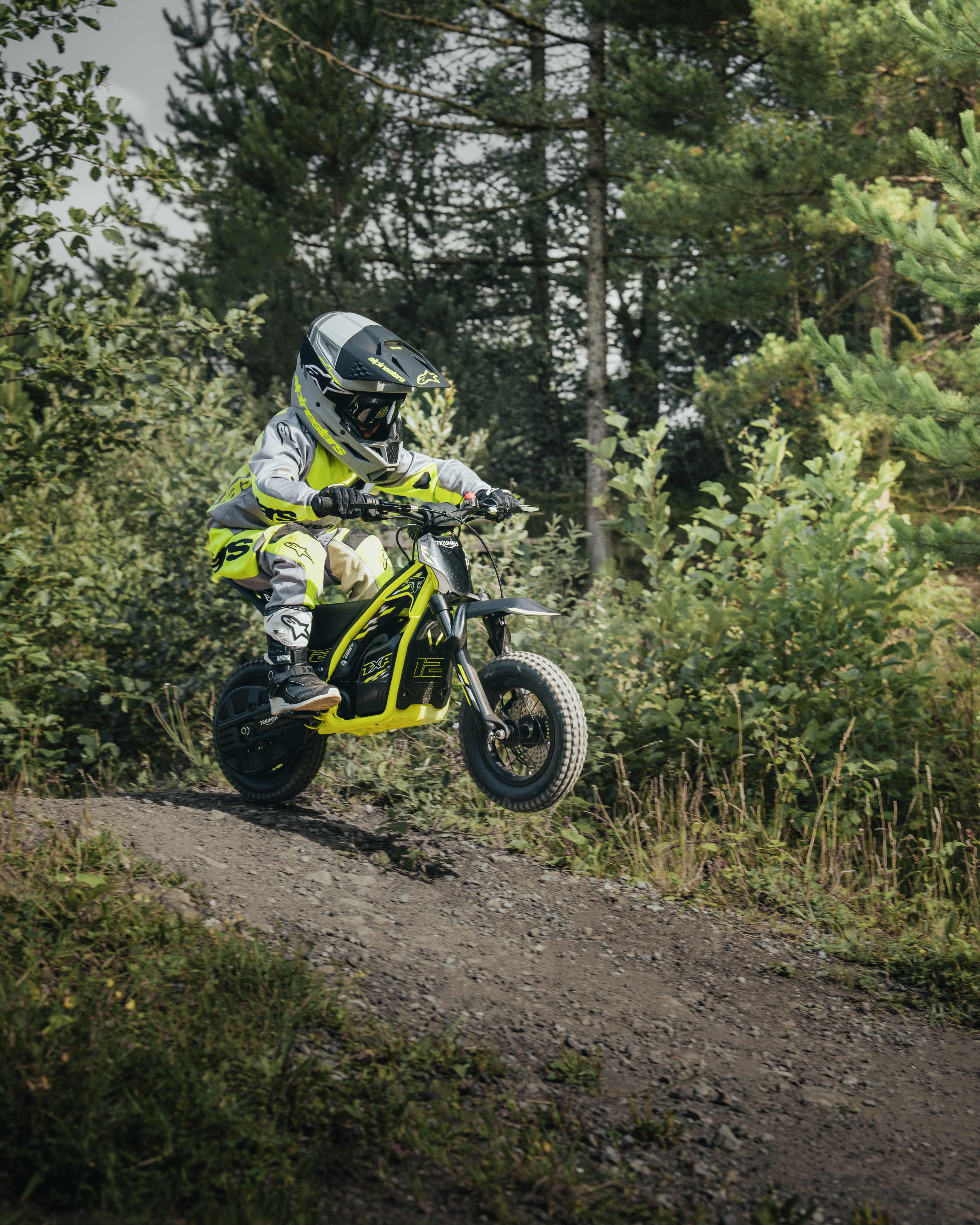 TXP-12 powered by OSET bike going down a small slope in a forest.