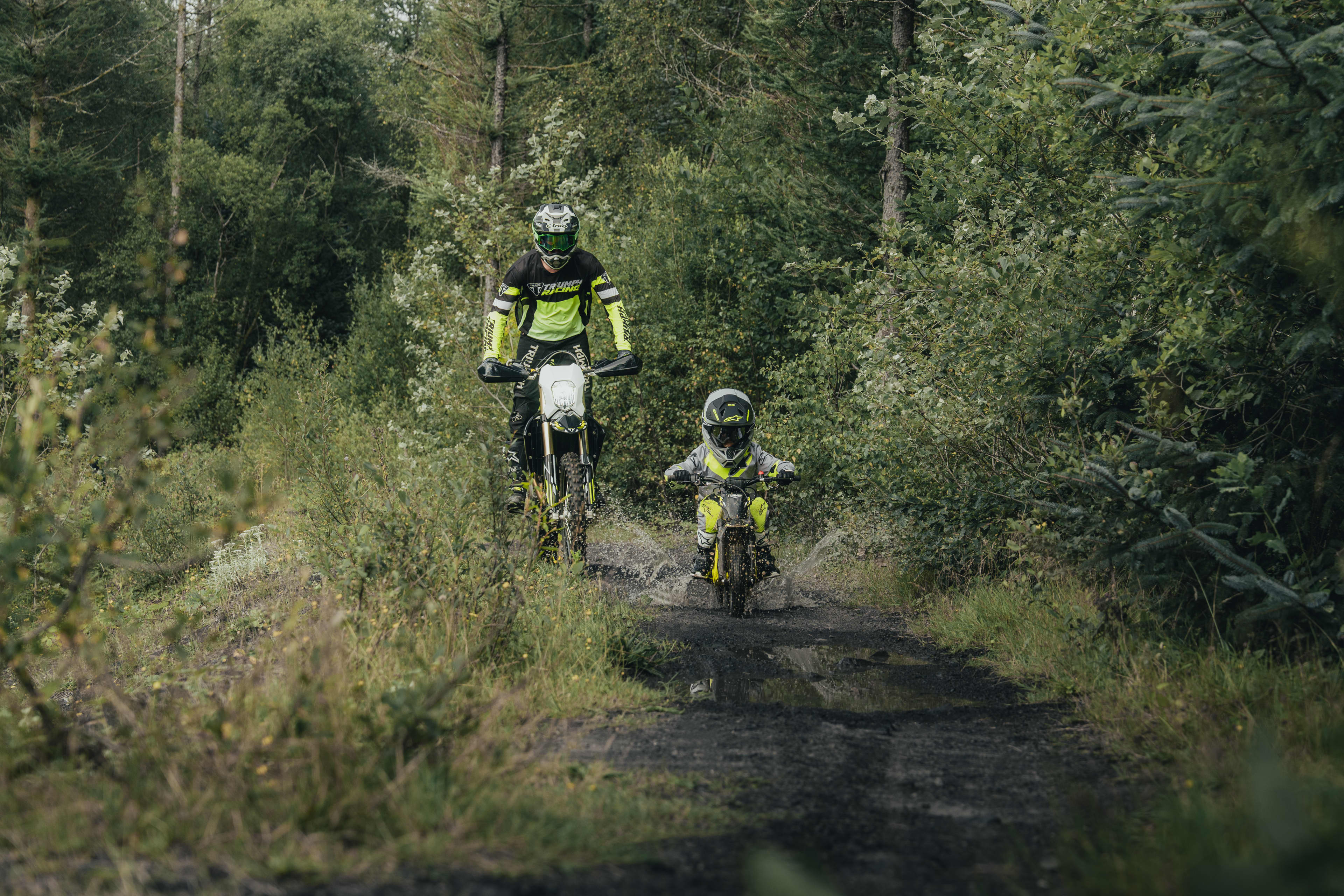 TXP-12 powered by OSET bike with an adult supervision following the young rider on the forest trail.