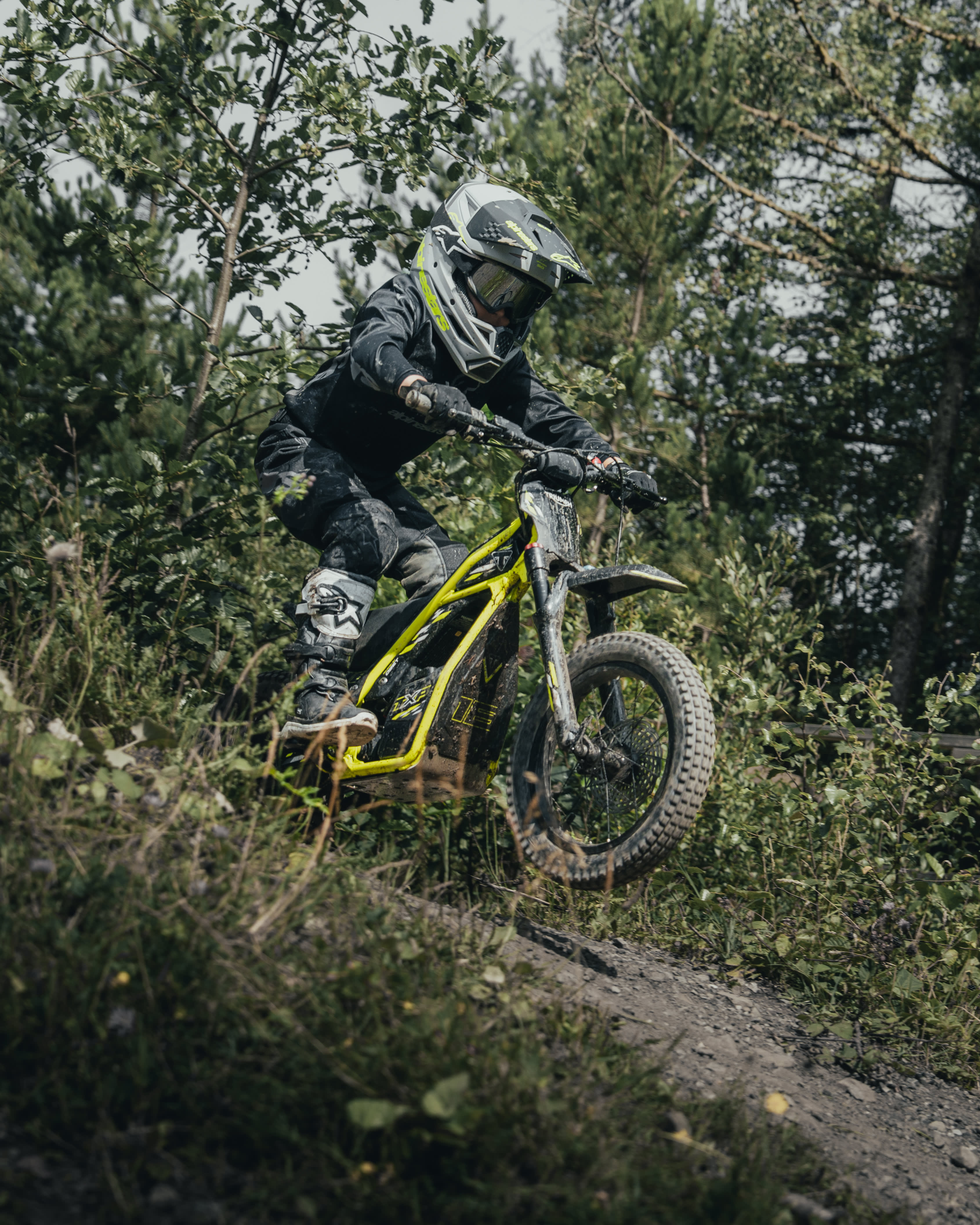Young rider out exploring the forest on the Triumph TXP-16 powered by OSET bike.