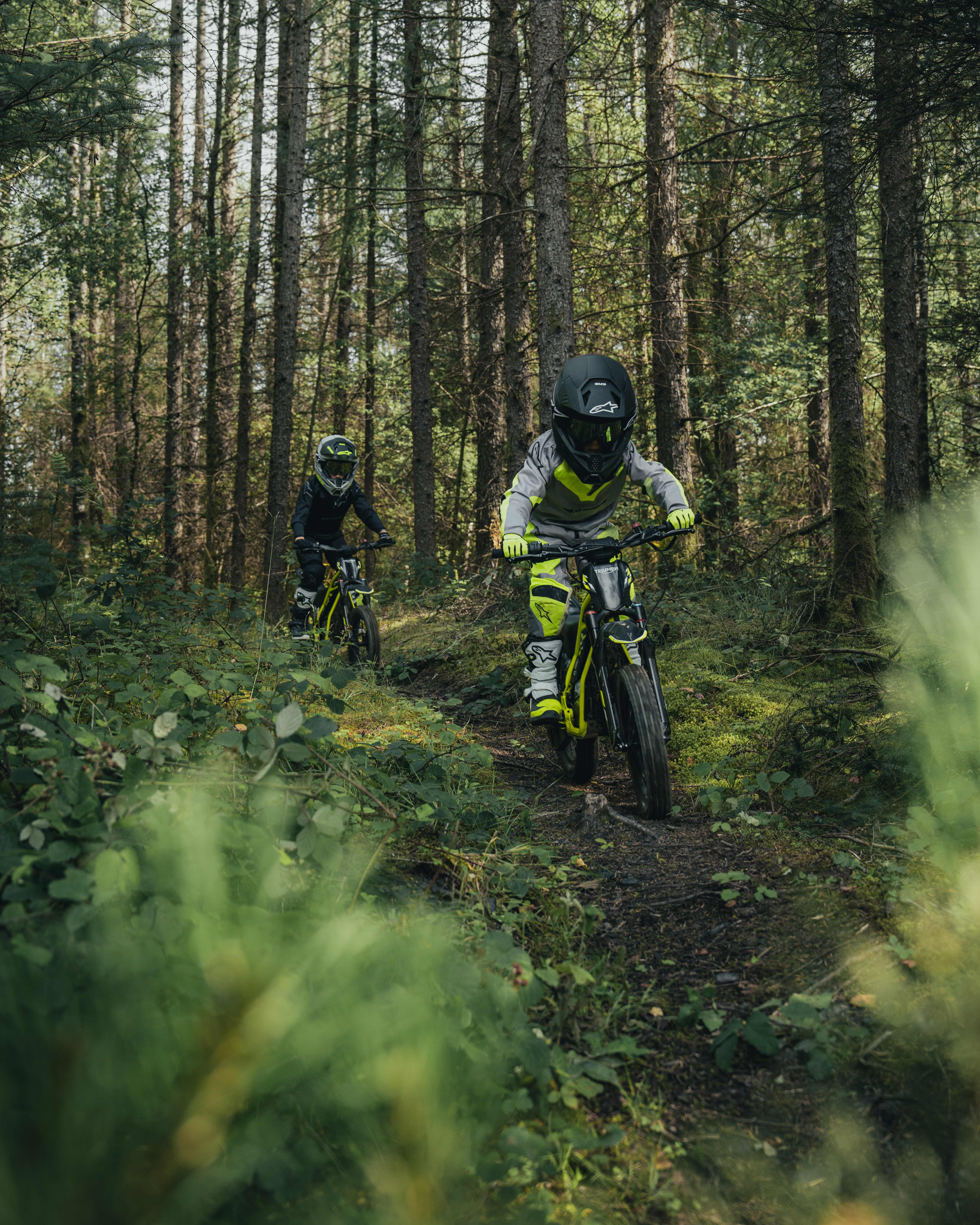 Young riders out exploring the forest on the Triumph TXP-16 powered by OSET bikes.