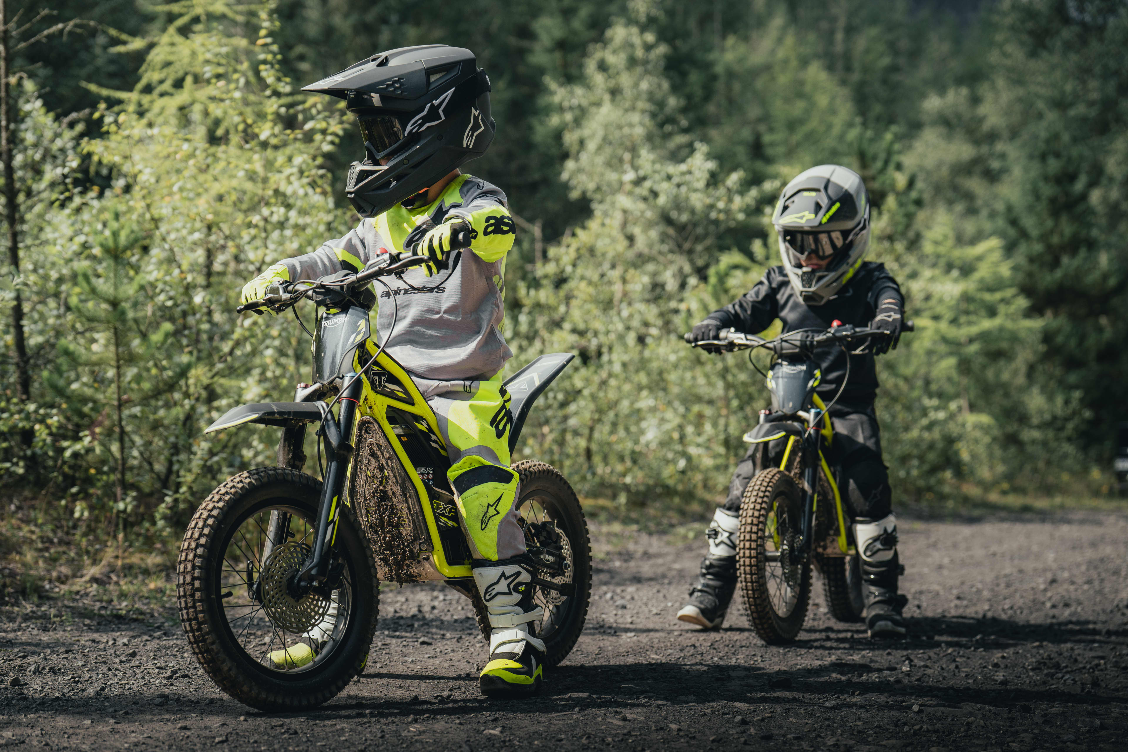 TXP-16 powered by OSET in a forest setting with two young riders.
