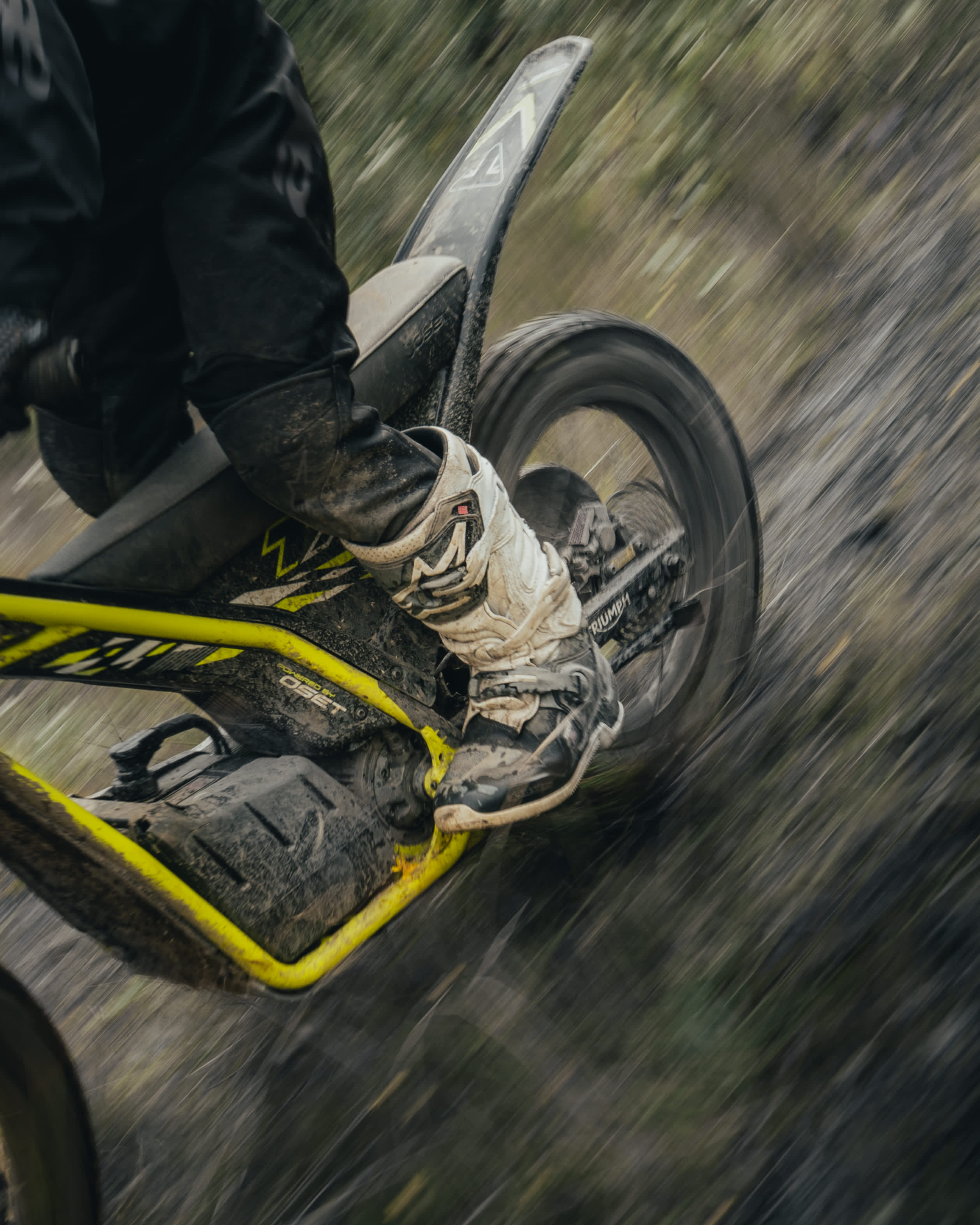 TXP-20 powered by OSET rear view of the wheel going through a muddy trail.