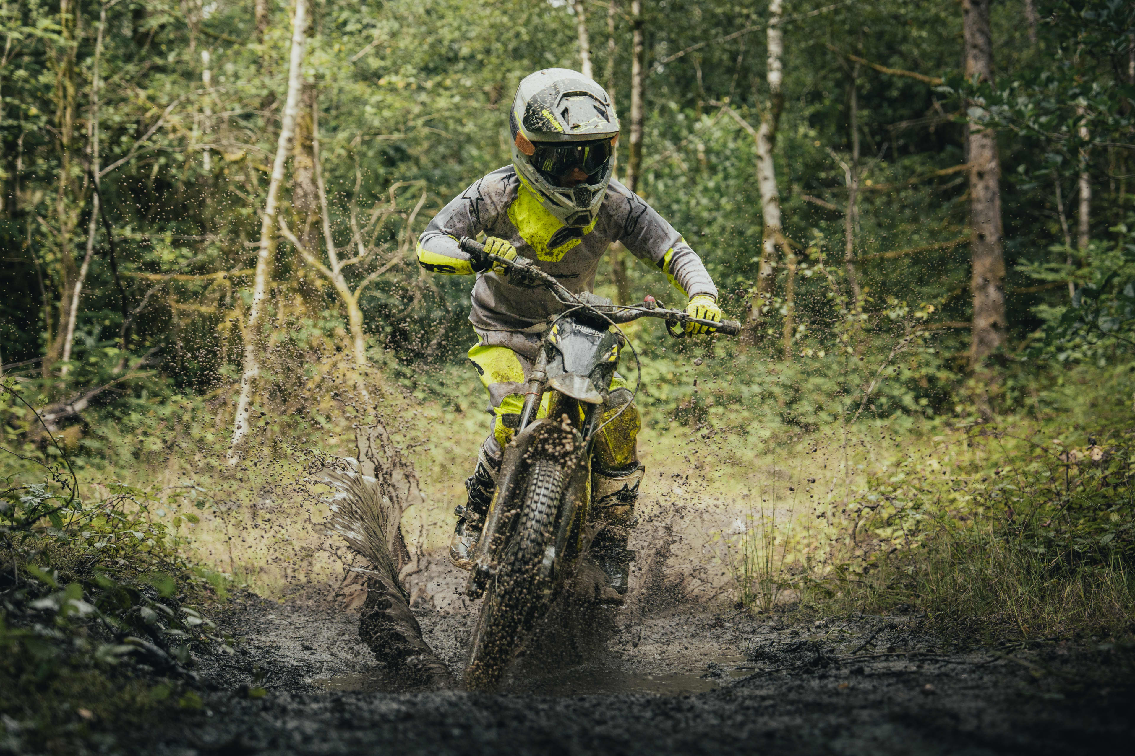 TXP-20 powered by OSET with a young rider going through a muddy puddle.