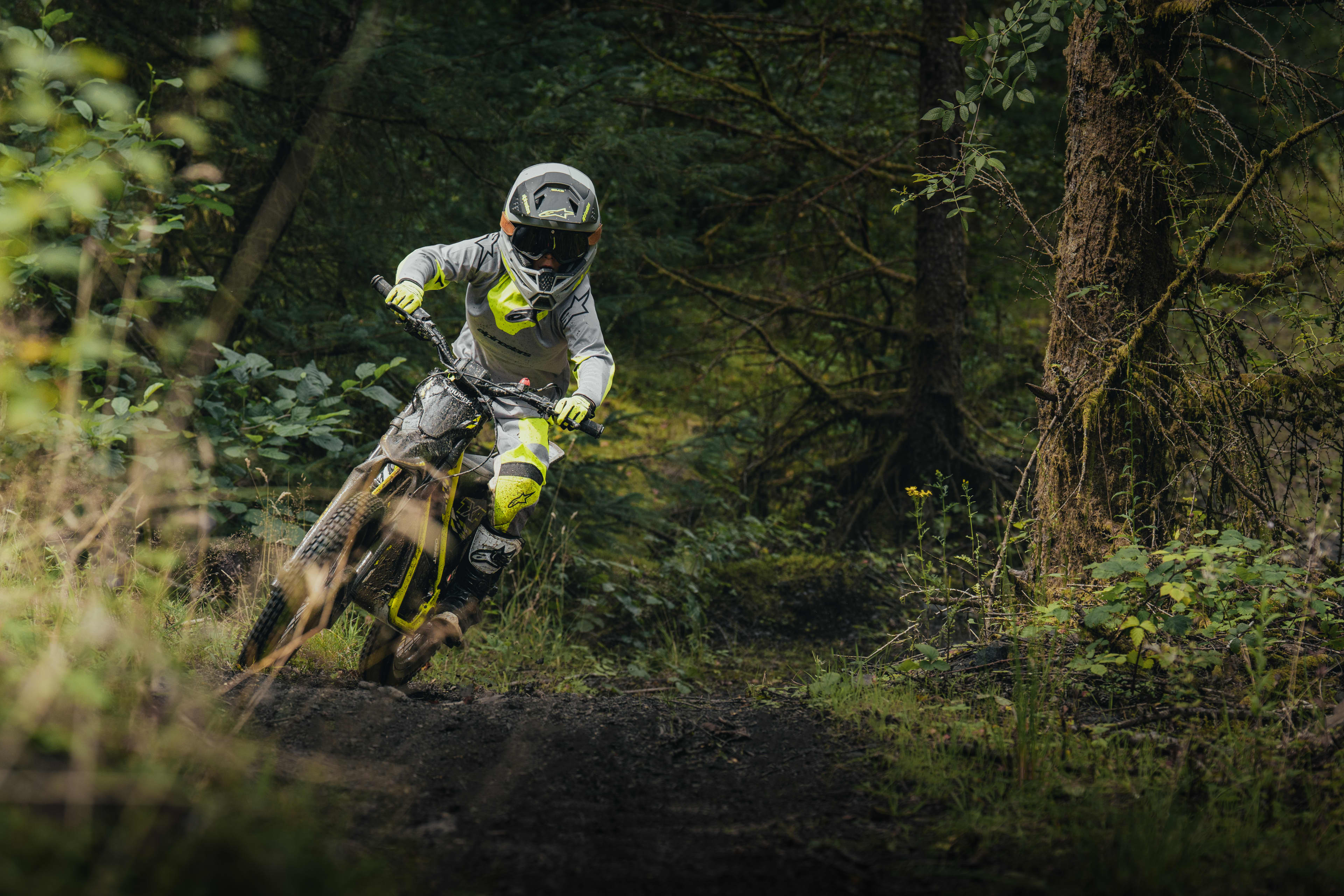 TXP-20 powered by OSET bike going around a bend in the forest.