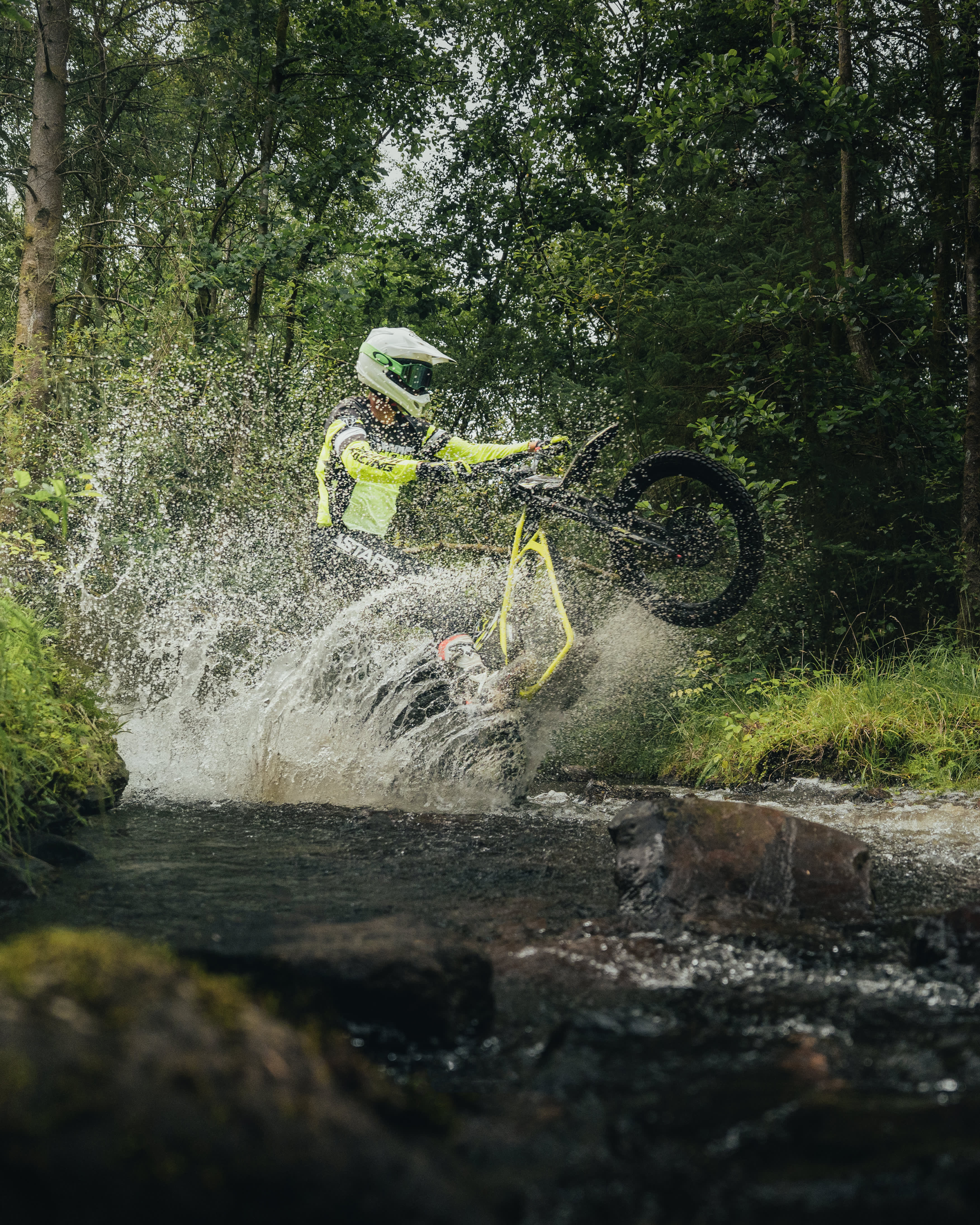 Triumph TXP-24 electric bike going through a stream.