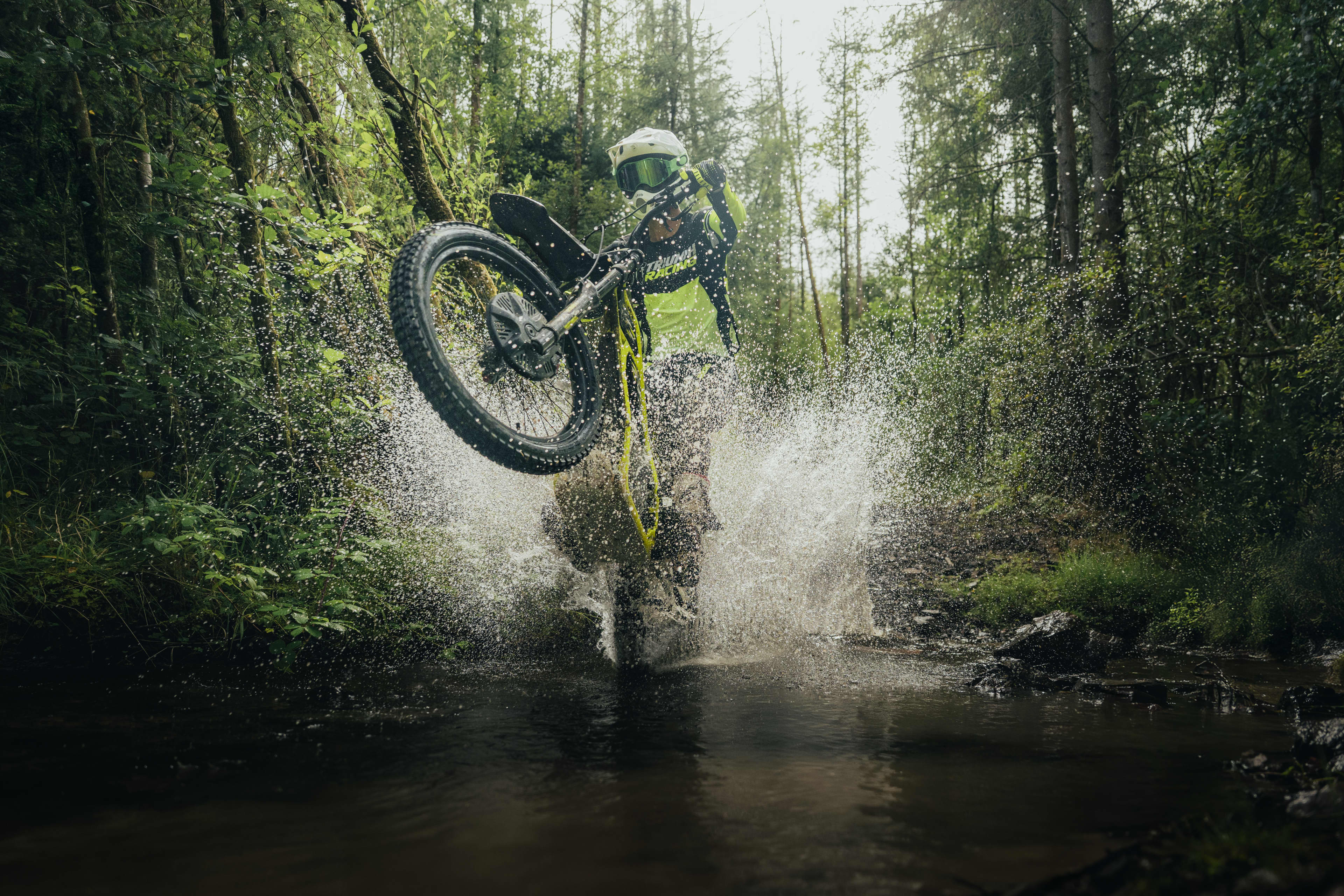 Triumph TXP-24 electric bike doing a trick in the water; to showcase how the electric bike is waterproof.